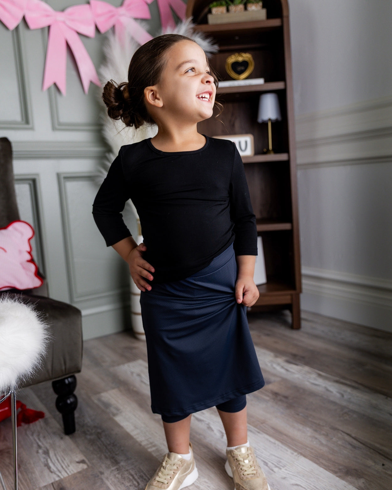 Model wearing Nuggles® Girls' All-Sport Skirt in Navy