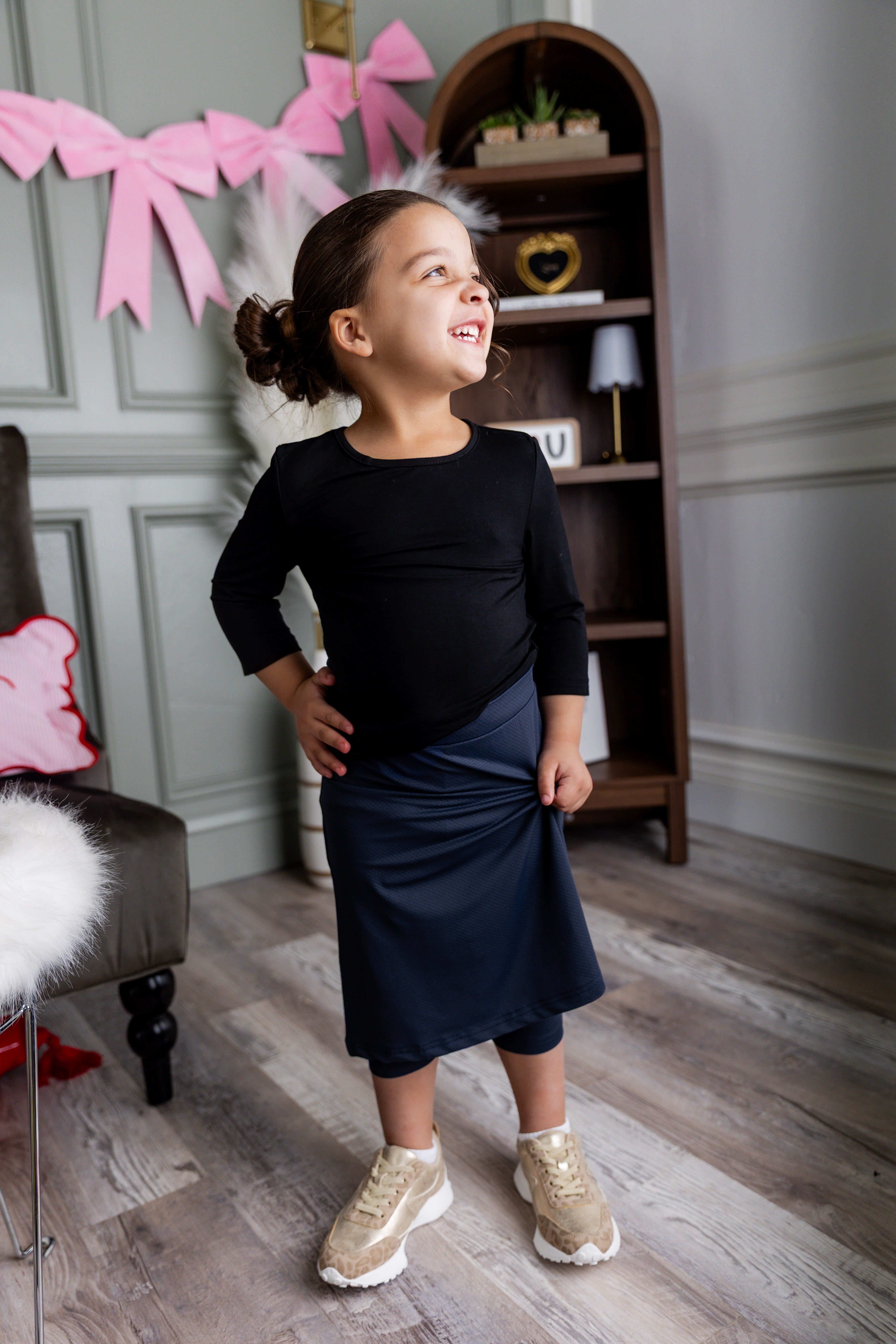 Model wearing Nuggles® Girls' All-Sport Skirt in Navy