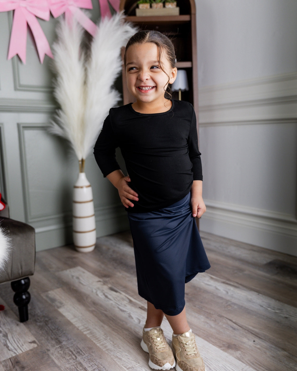 Model wearing Nuggles® Girls' All-Sport Skirt in Navy