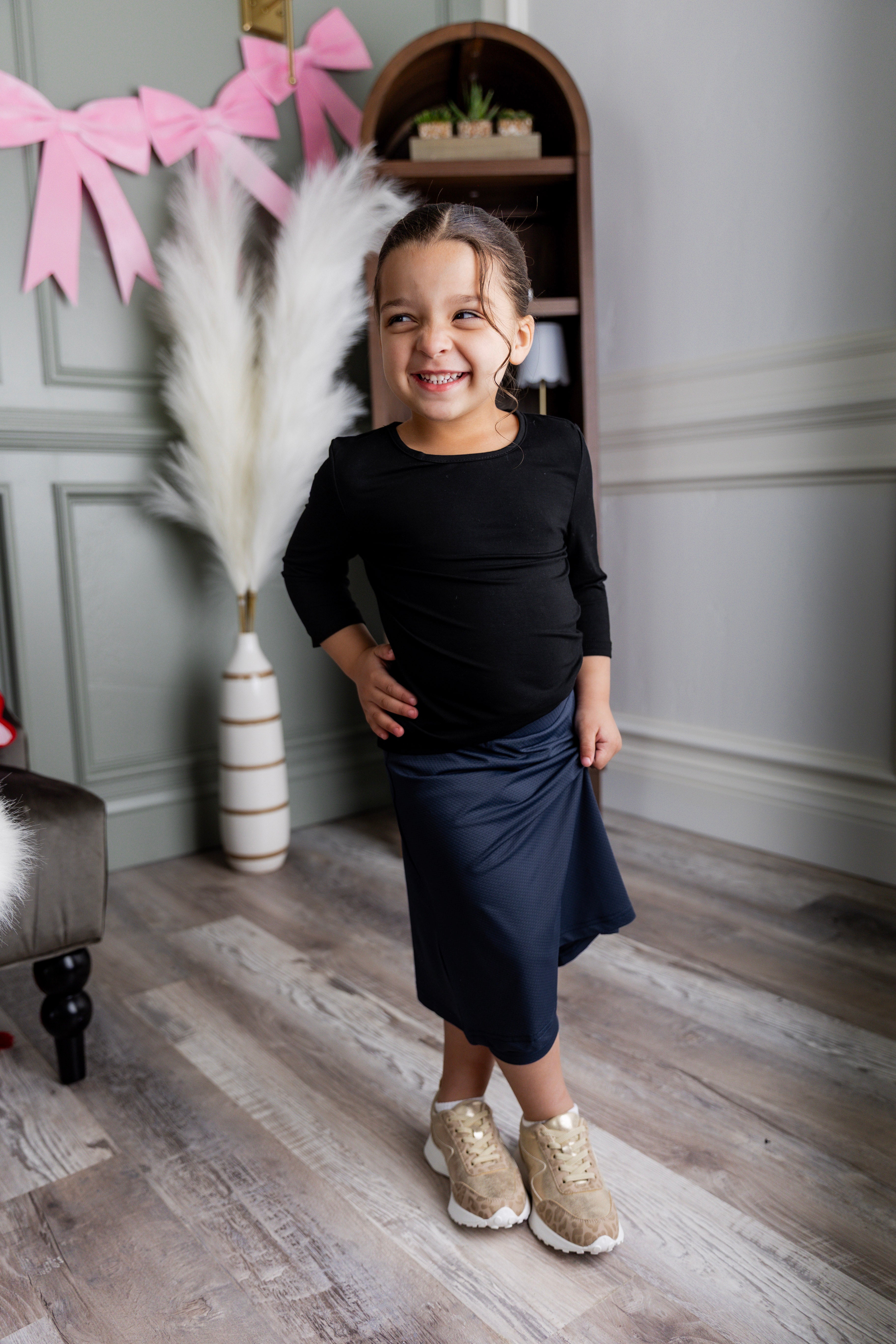 Model wearing Nuggles® Girls' All-Sport Skirt in Navy