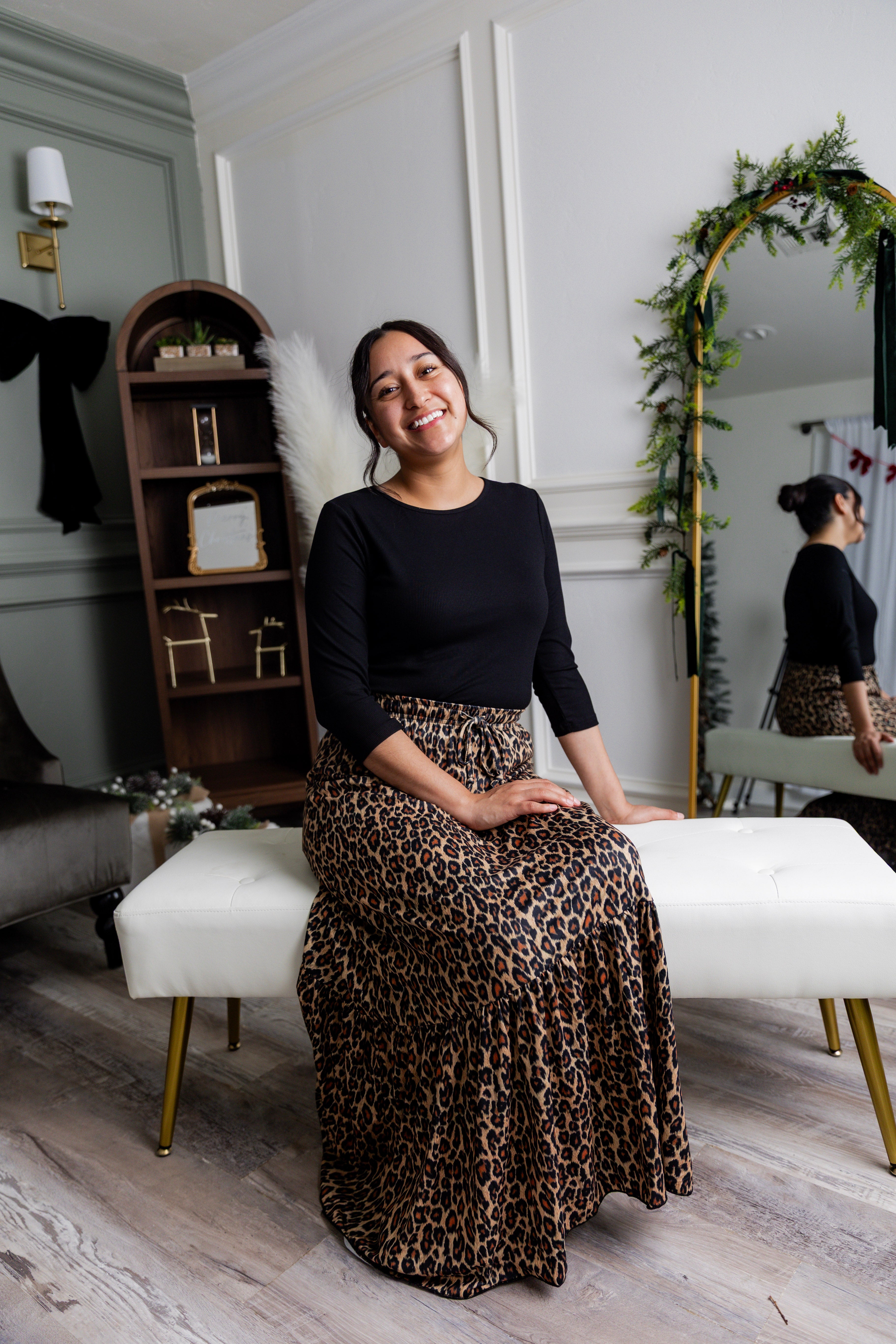Model wearing the Nuggles® Sage Skirt in leopard print, designed with a flowy tiered hem and comfortable elastic waistband.