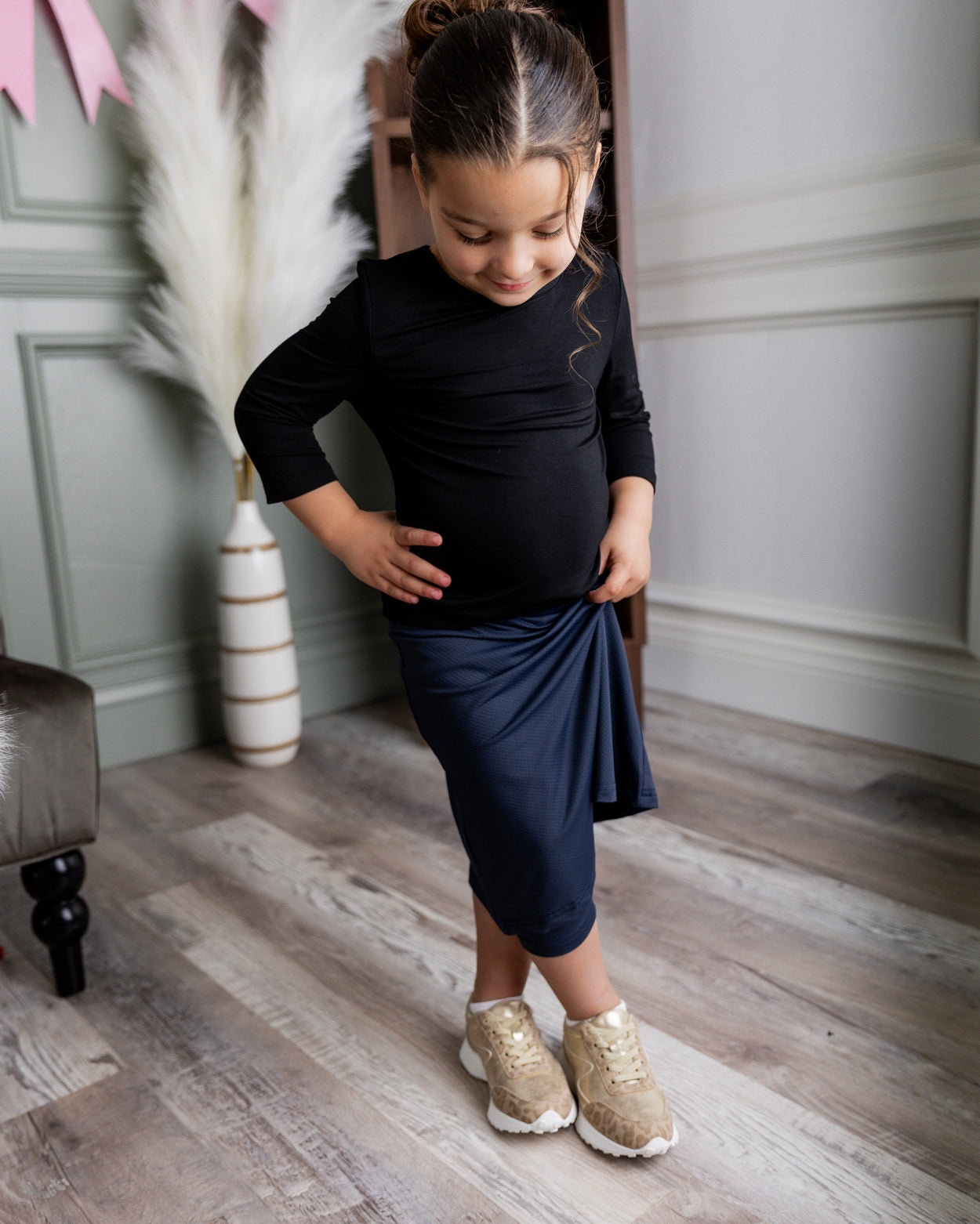 Model wearing Nuggles® Girls' All-Sport Skirt in Navy
