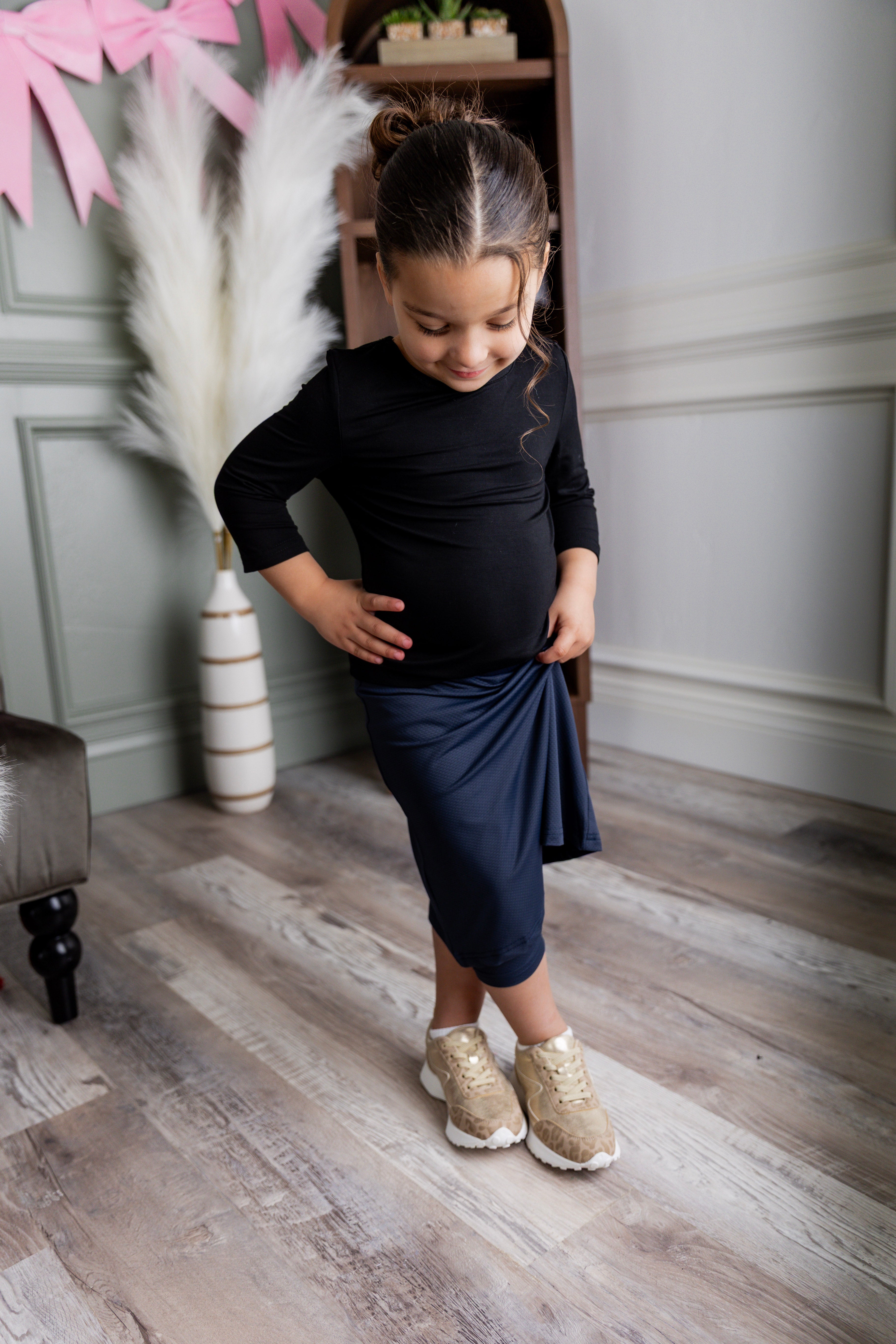 Model wearing Nuggles® Girls' All-Sport Skirt in Navy