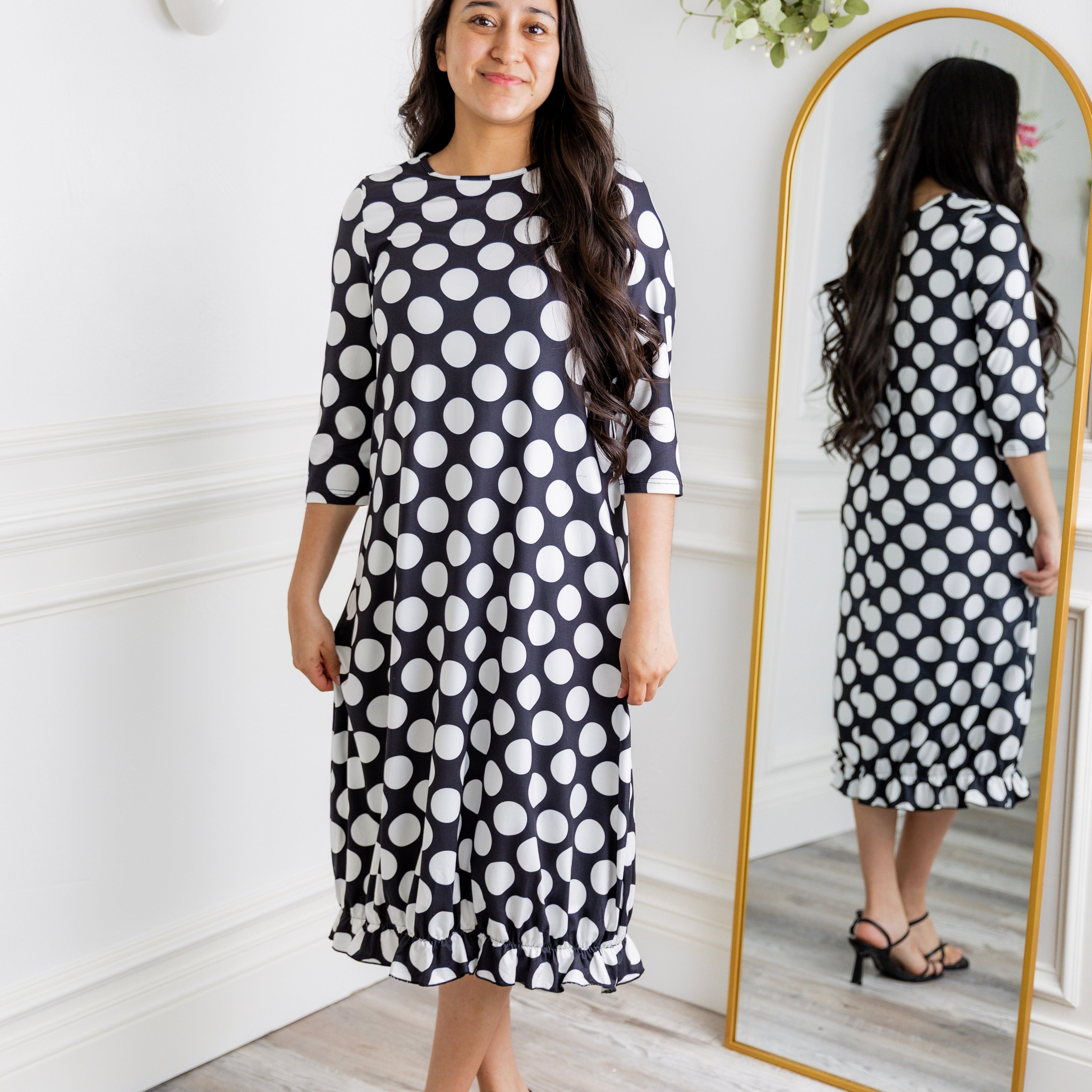 Model wearing our Nuggles® modest Bristol midi dress with 3/4 sleeves and elastic ruffle hem in various prints.