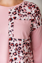 Model wearing the Nuggles® Harlow Top with red and navy color block design.