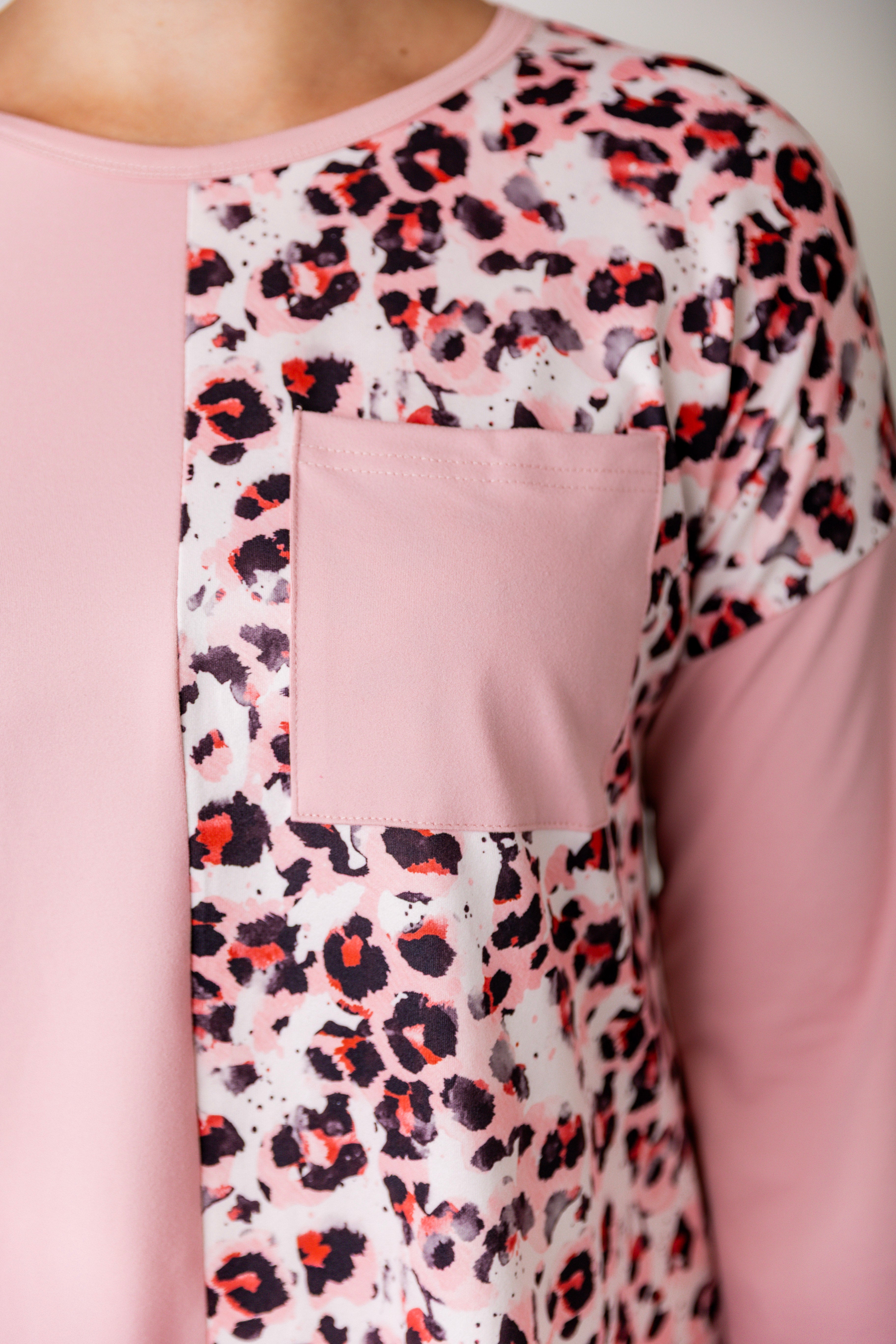 Model wearing the Nuggles® Harlow Top with red and navy color block design.