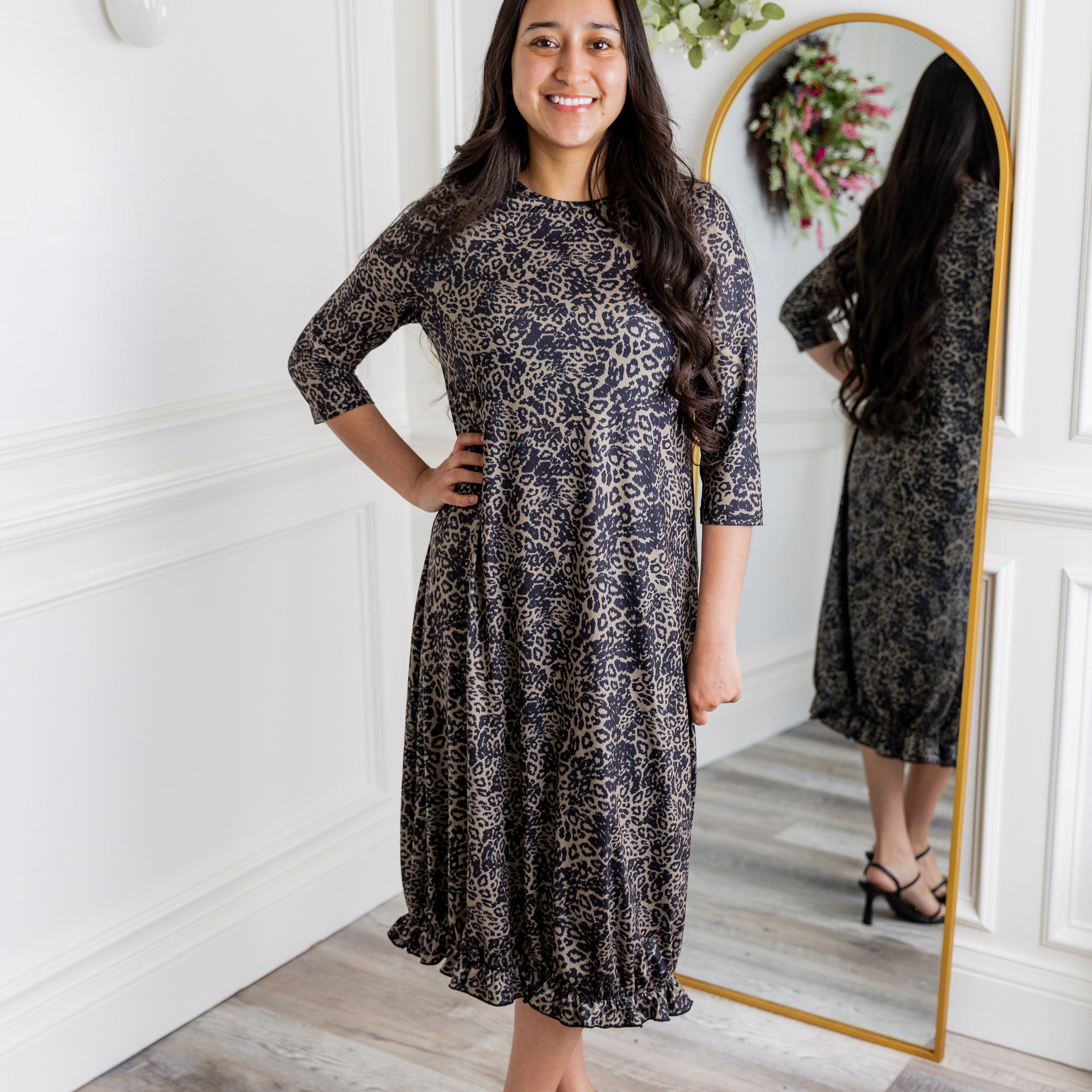 Model wearing our Nuggles® modest Bristol midi dress with 3/4 sleeves and elastic ruffle hem in various prints.