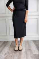 Model wearing a 27-inch classic lightweight midi skirt with an elastic waistband, styled modestly for everyday or church wear.