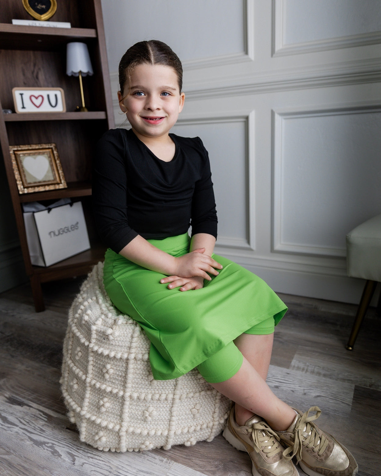 Model wearing Nuggles® Girls' All-Sport Skirt in Green