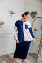 Model wearing the Nuggles® Harlow Top with red and navy color block design.