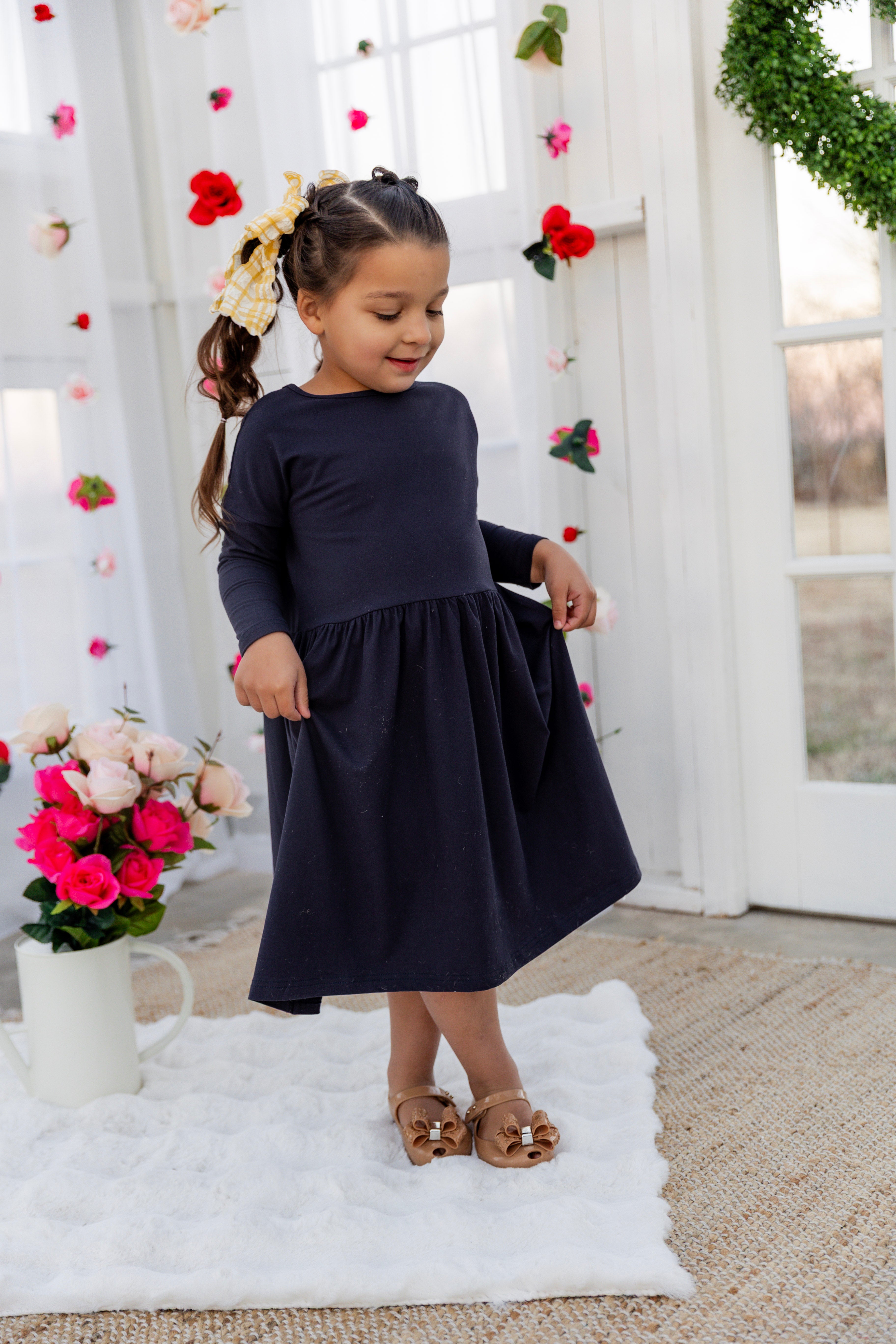 Model wearing the Nuggles® Girls' Farah Dress in Navy