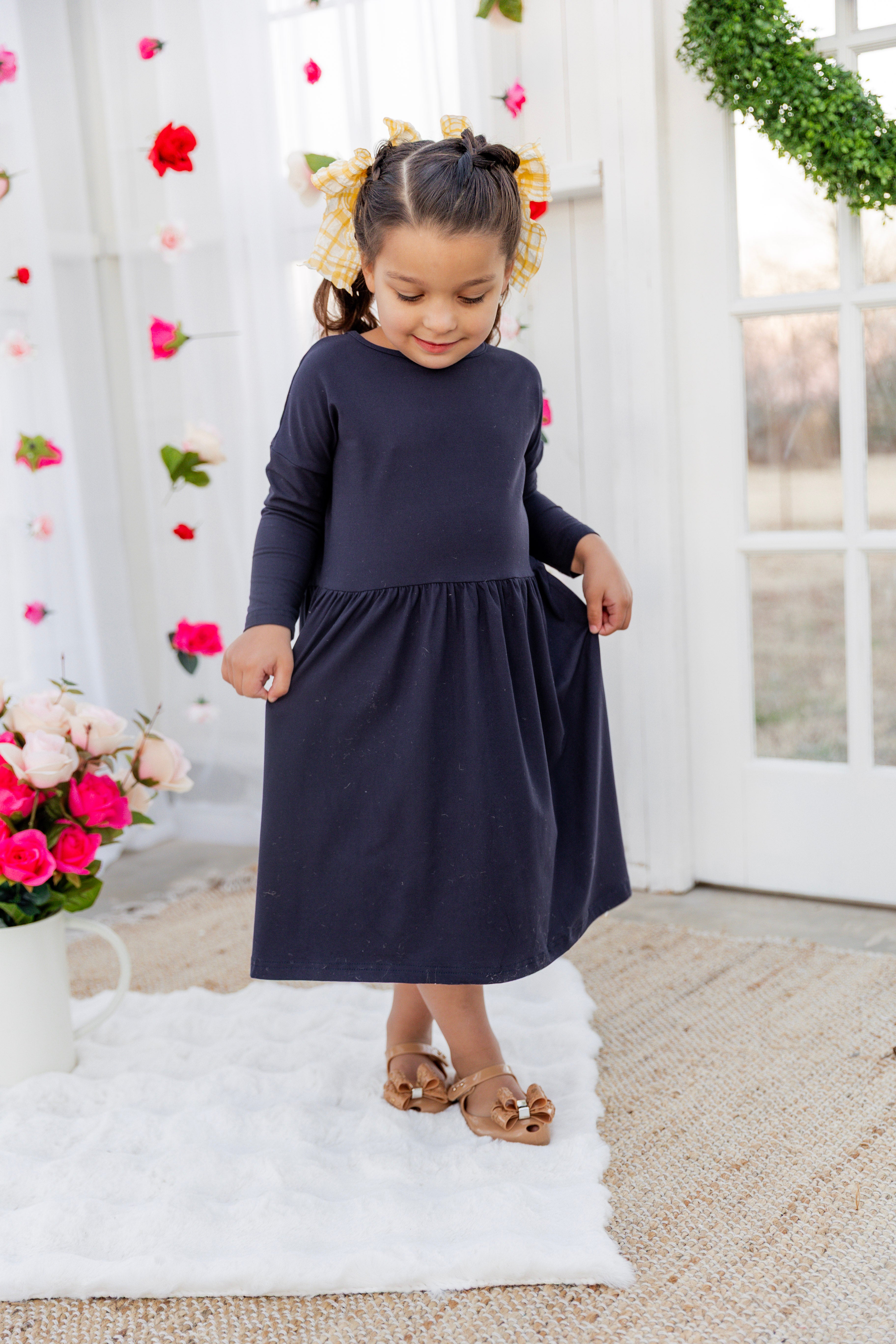 Model wearing the Nuggles® Girls' Farah Dress in Navy
