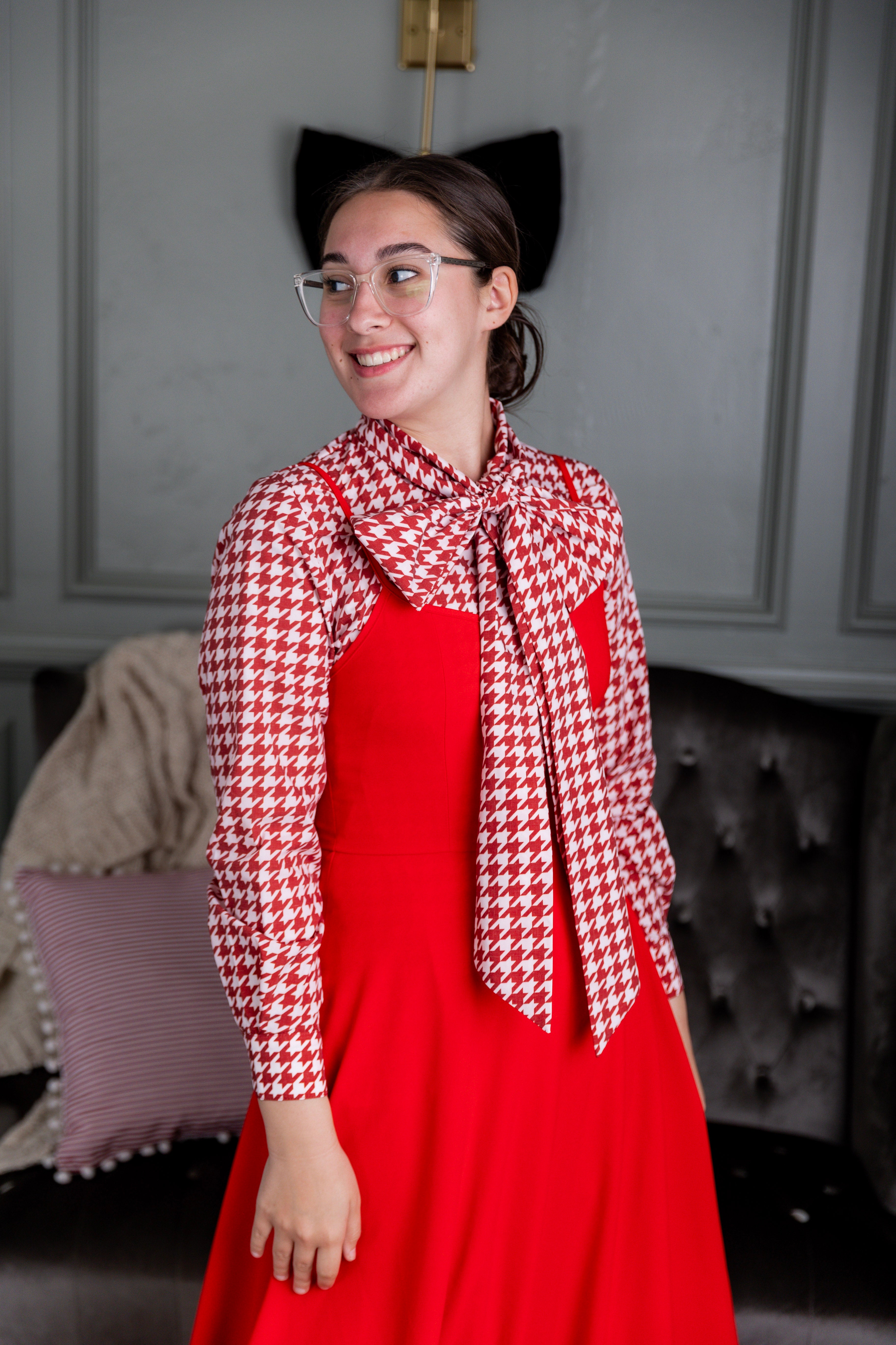 Model wearing Nuggles® Felicity top with large bow tie neckline, modest women's blouse.