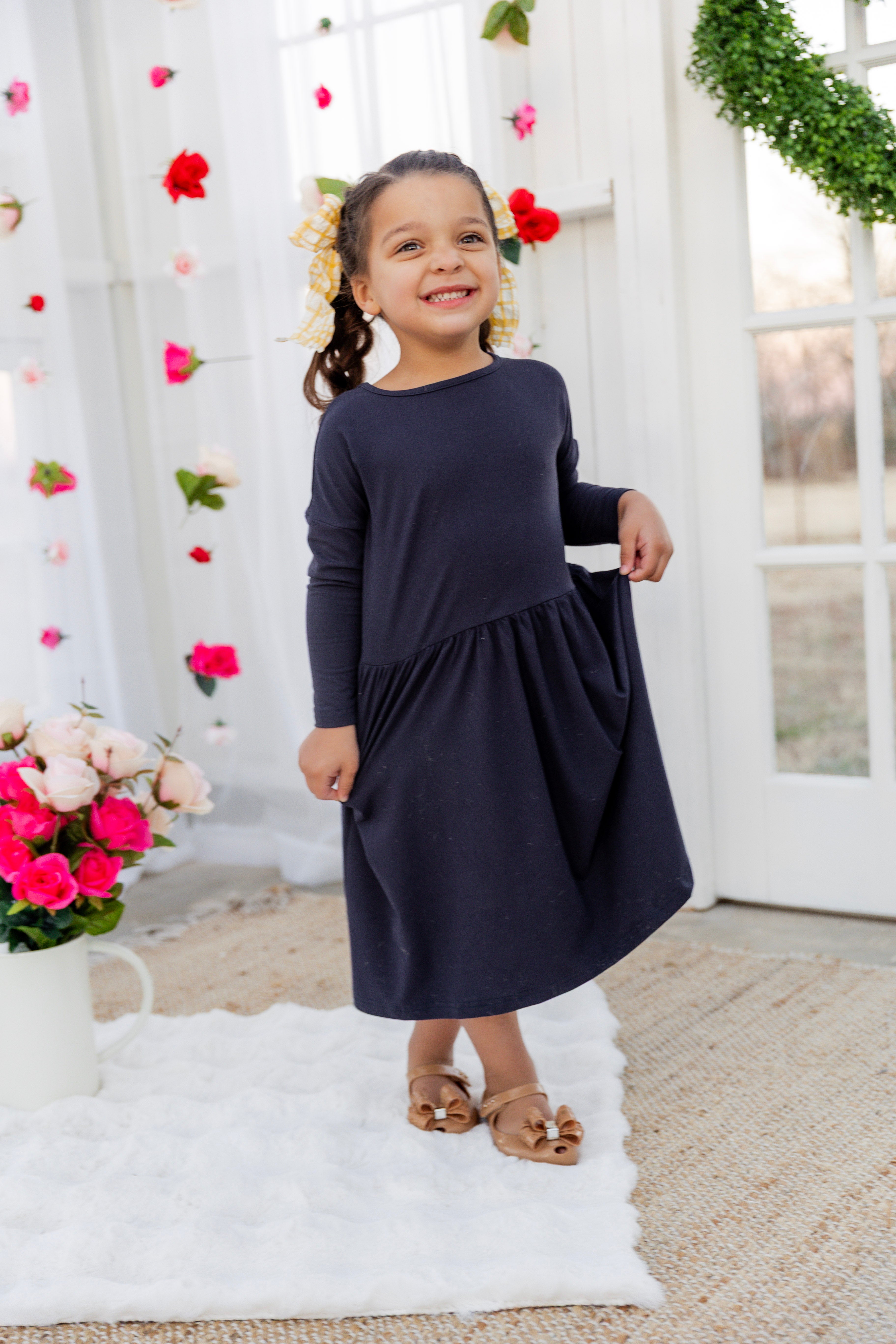 Model wearing the Nuggles® Girls' Farah Dress in Navy
