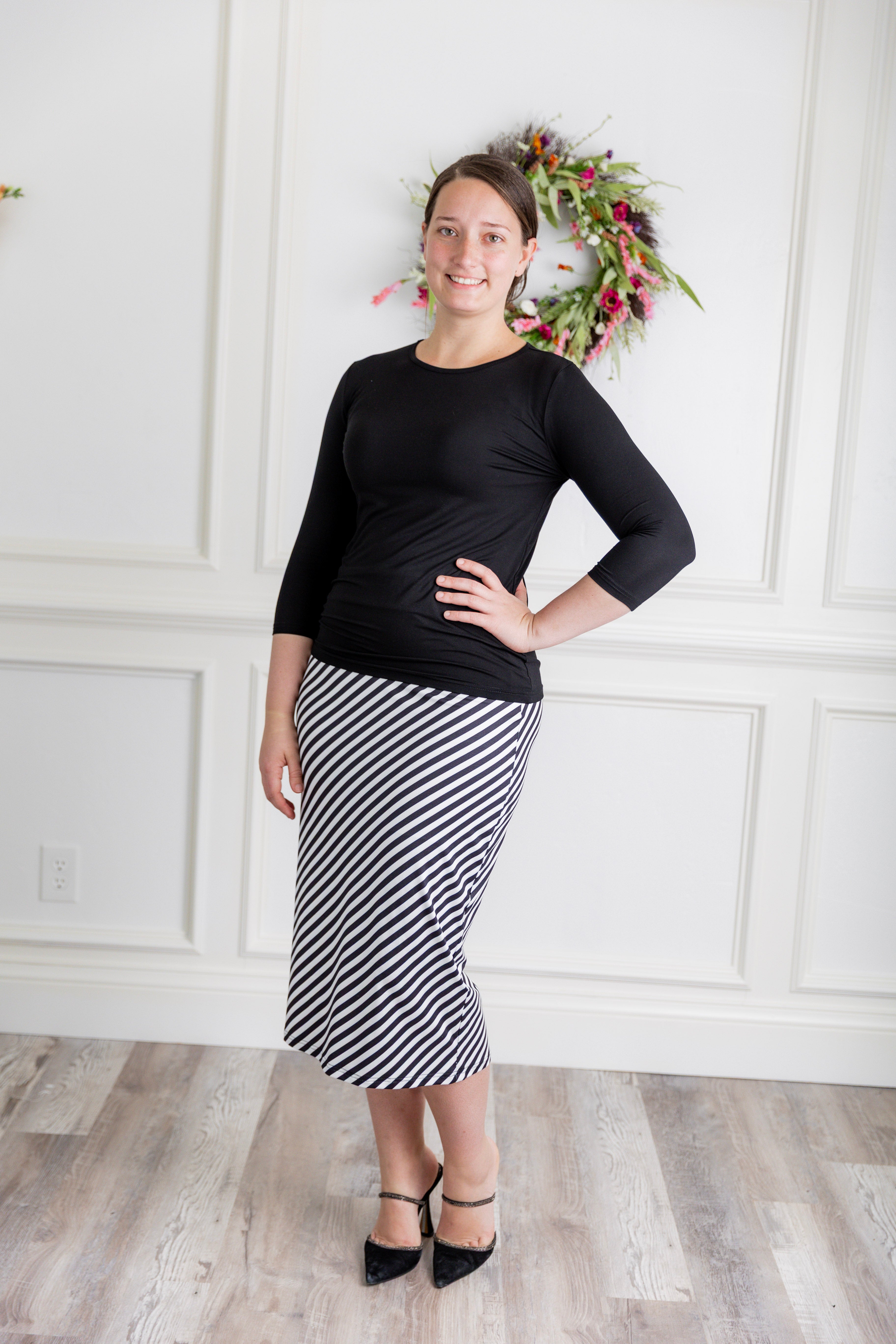Model showcasing  Nuggles® midi tee skirts in various solid colors, modest 27" and 31" lengths