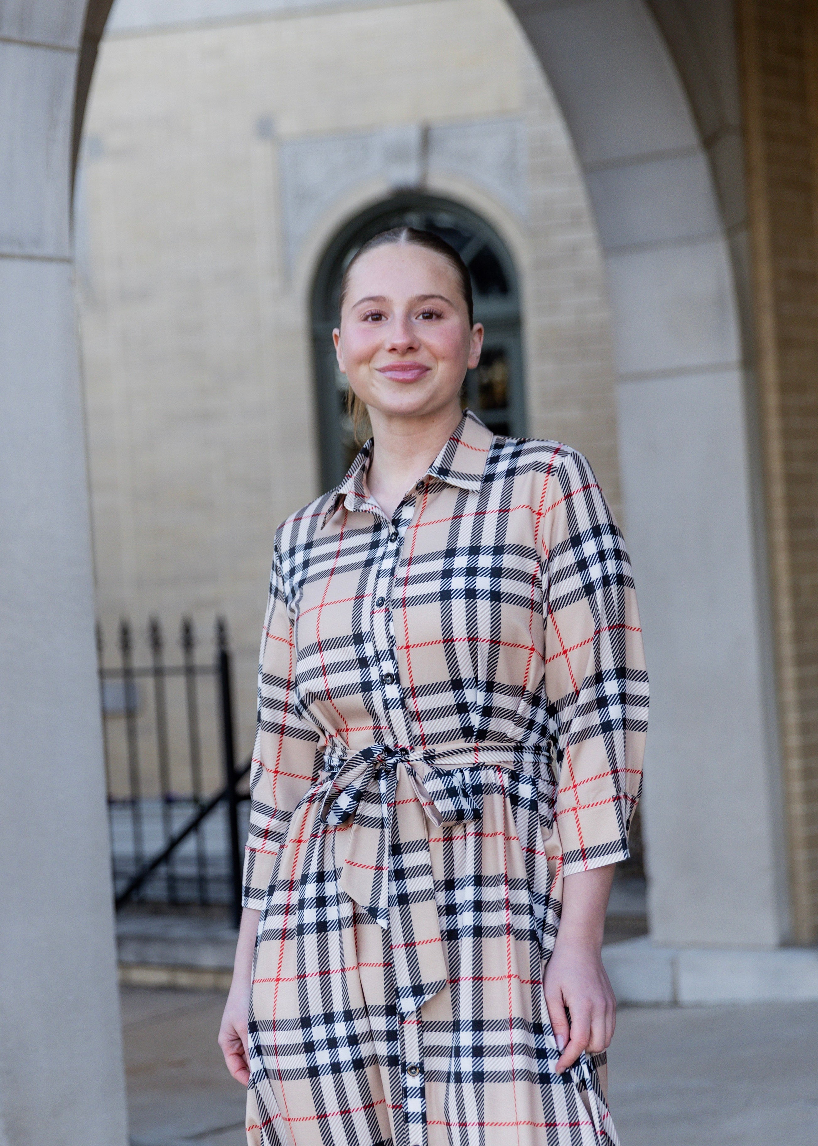 Model wearing the Nuggles® Rachel Dress in Sand Plaid