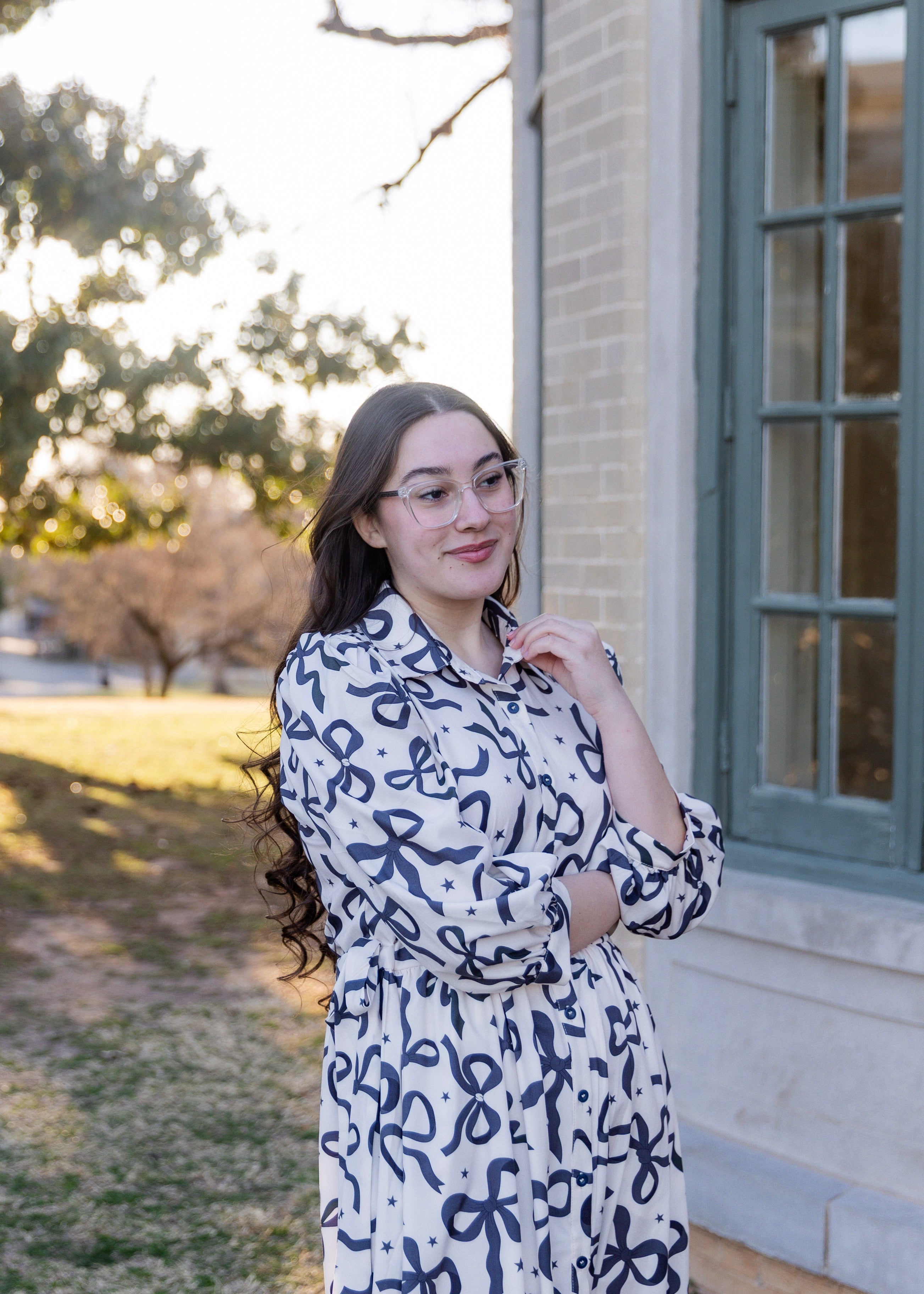 Model wearing the Nuggles® Leila Dress in Bow & Tell