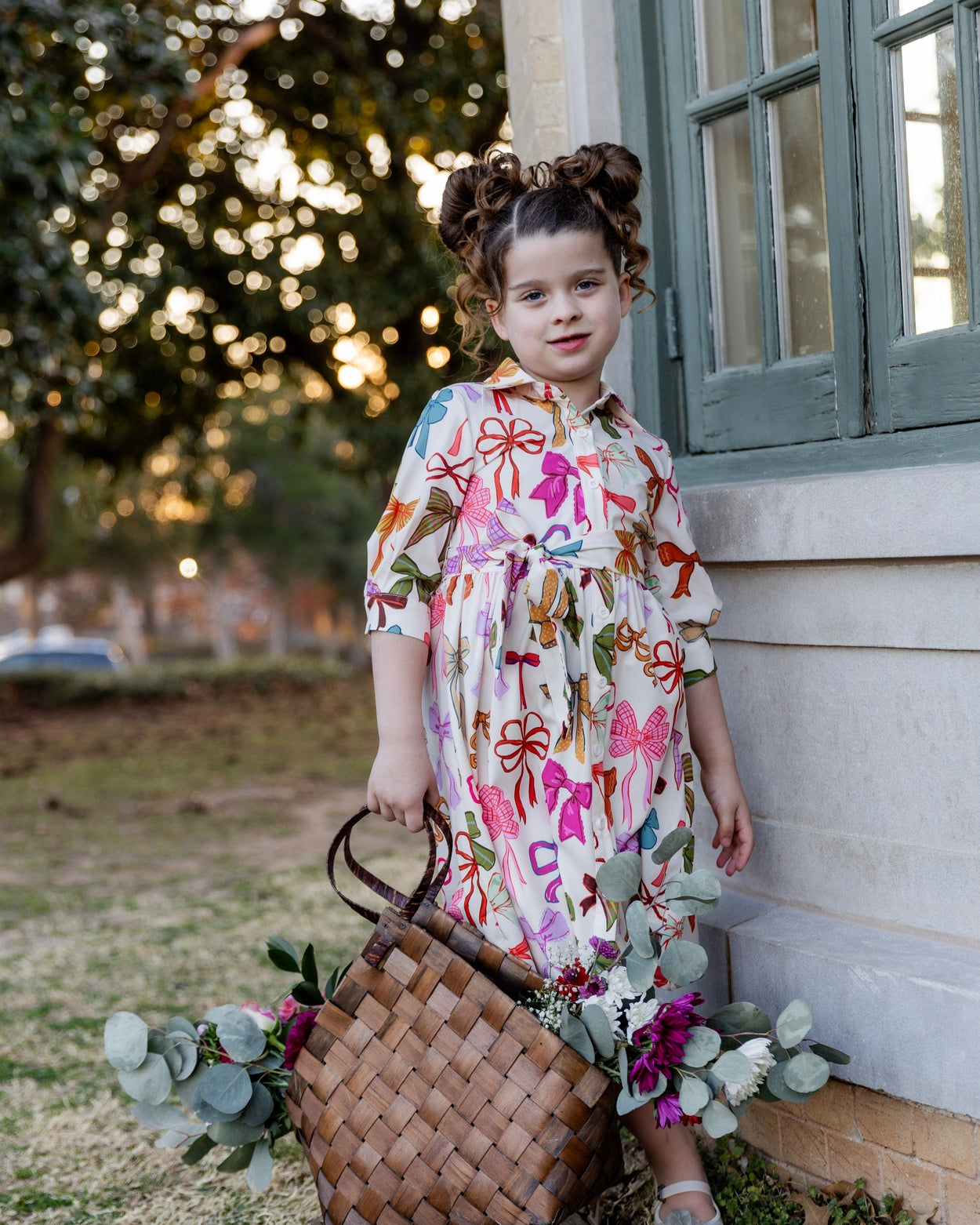 Model wearing the Nuggles® Girls' Rachel Dress in Bow Garden