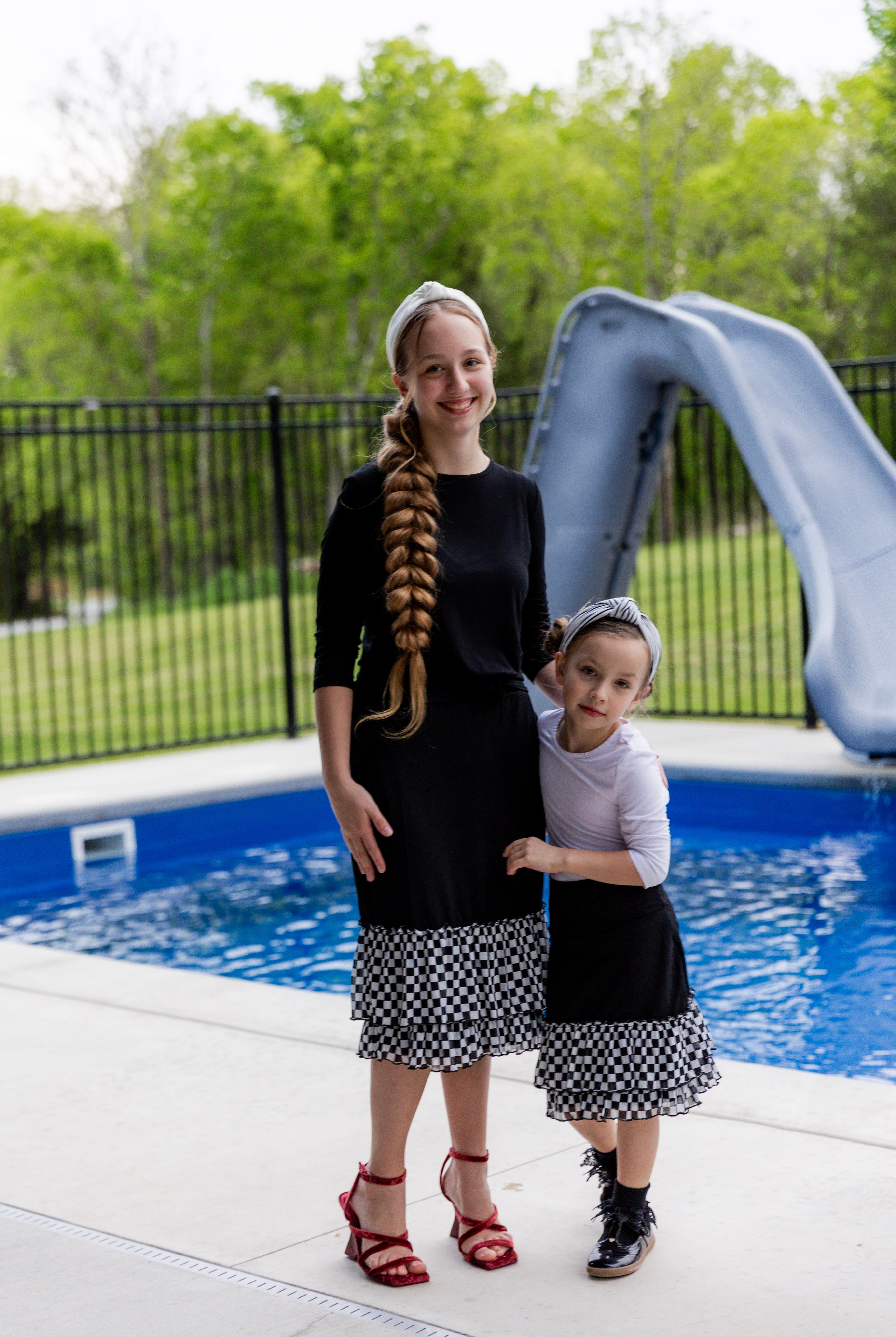 Modest girls’ ruffle slip with wide no-elastic waistband, perfect for layering under dresses and skirts.