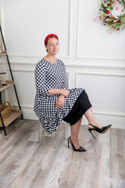 Modest women's black and white checkerboard ruffle tunic – Nuggles® Rose Top with 3/4 sleeves and swing hem.