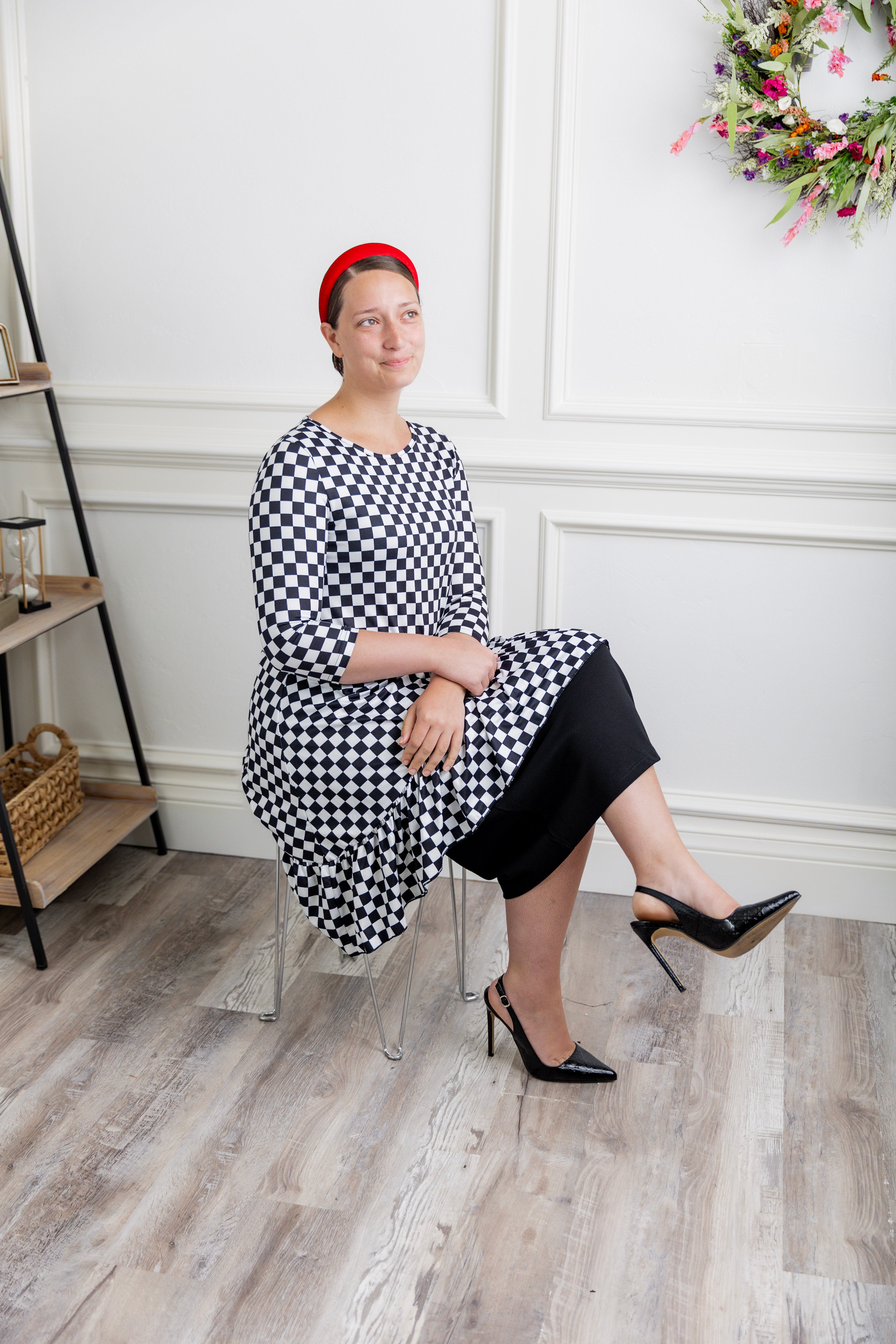 Modest women's black and white checkerboard ruffle tunic – Nuggles® Rose Top with 3/4 sleeves and swing hem.