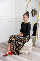 Model modeling Nuggles® Charay Dress with ¾ sleeves and high-low hem. Modest and stylish A-line dress with flattering fit.