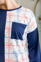 Model wearing the Nuggles® Harlow Top with red and navy color block design.