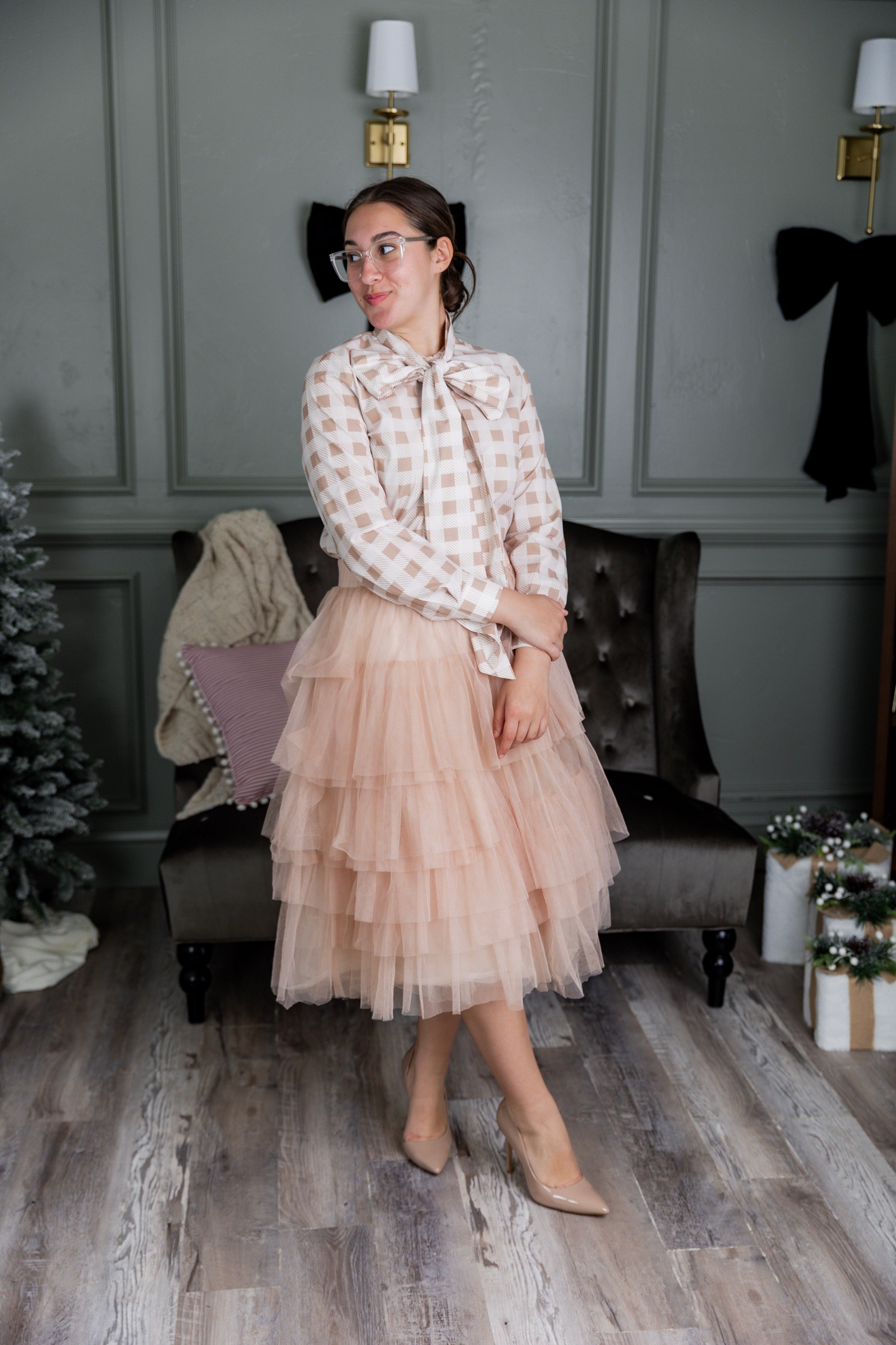 Model wearing Nuggles® Felicity top with large bow tie neckline, modest women's blouse.