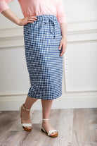 Woman in a modest 27-inch blue gingham knit skirt featuring side pockets and a drawstring waistband.