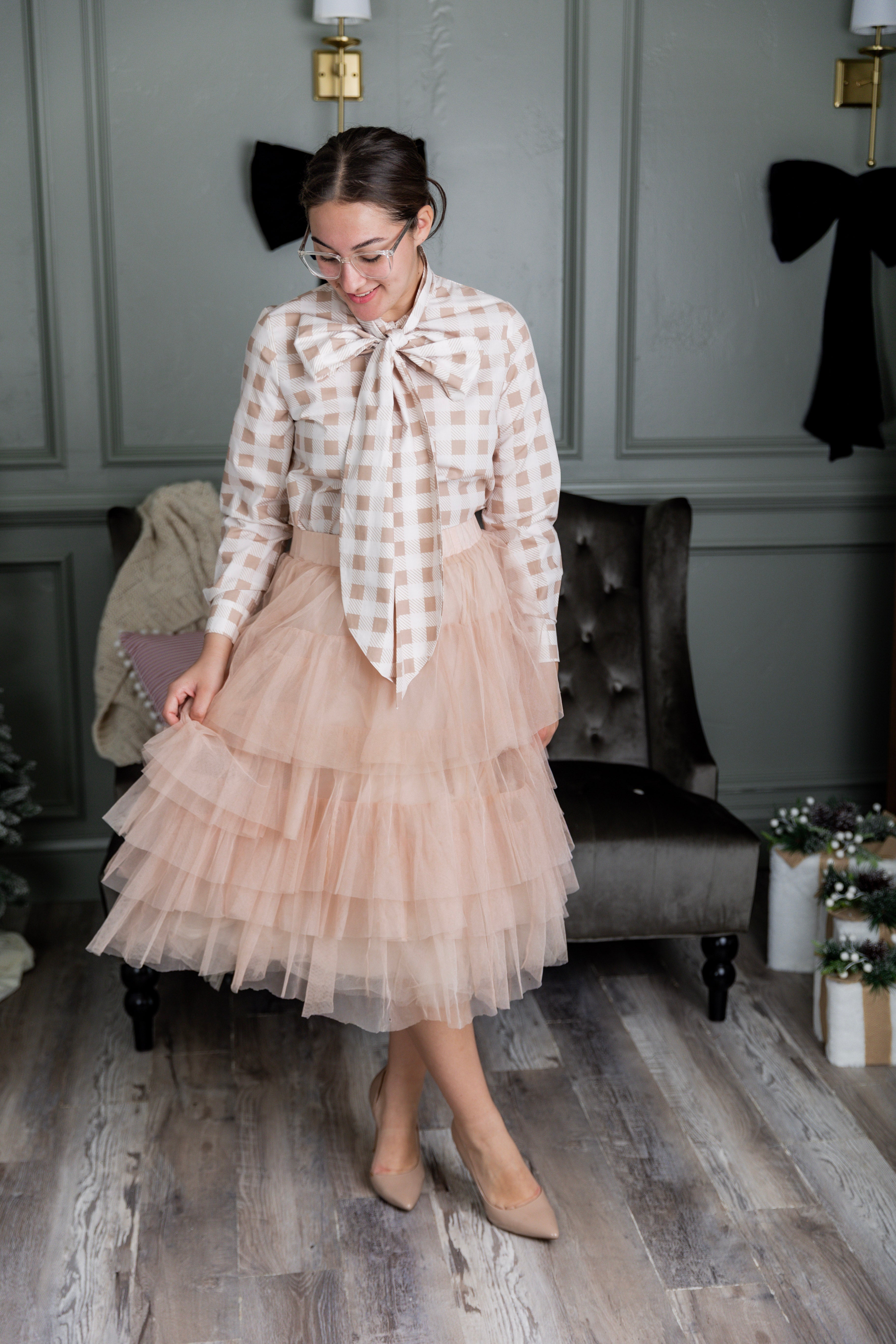 Model wearing Nuggles® Felicity top with large bow tie neckline, modest women's blouse.