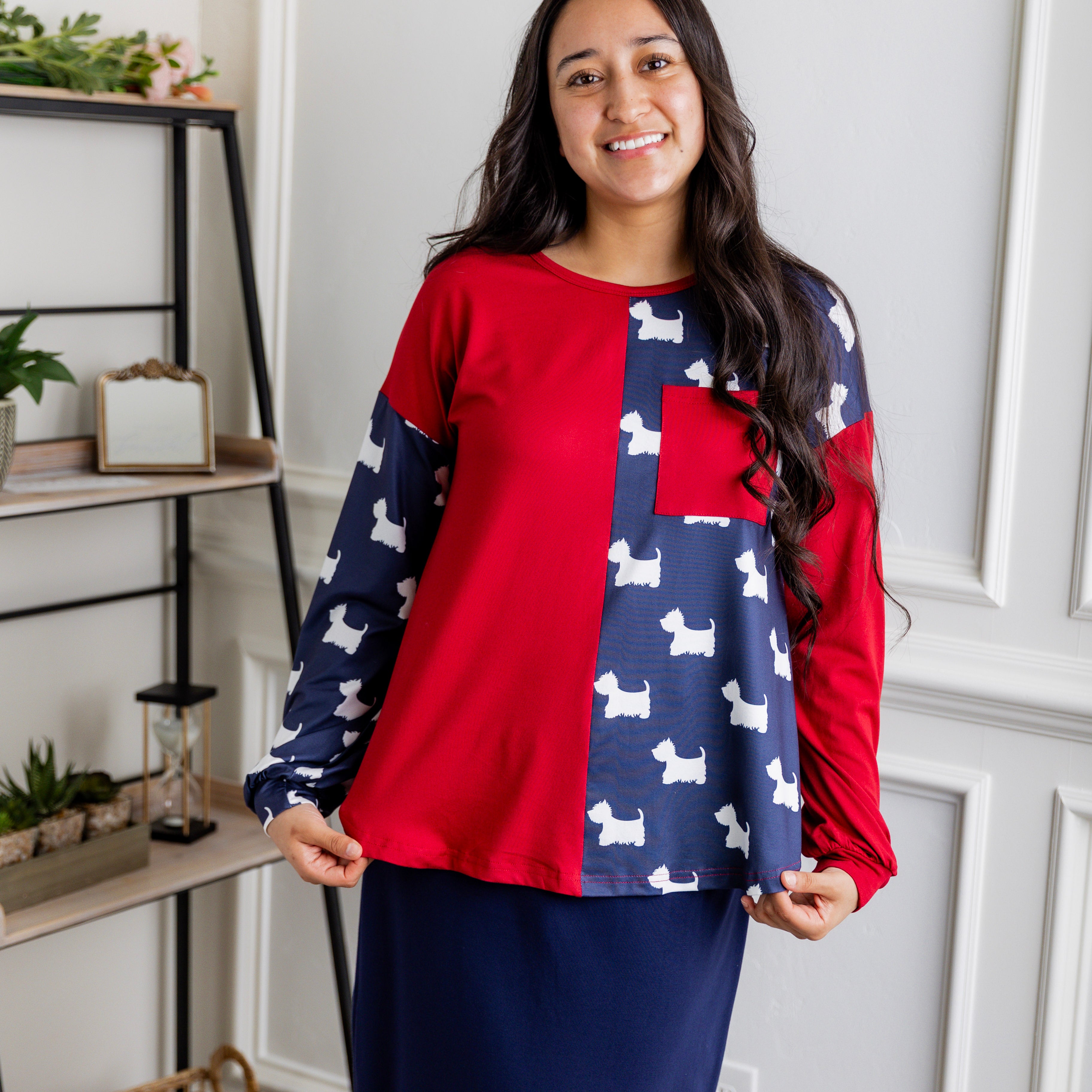 Model wearing the Nuggles® Harlow Top with red and navy color block design.