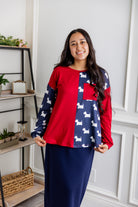Model wearing the Nuggles® Harlow Top with red and navy color block design.