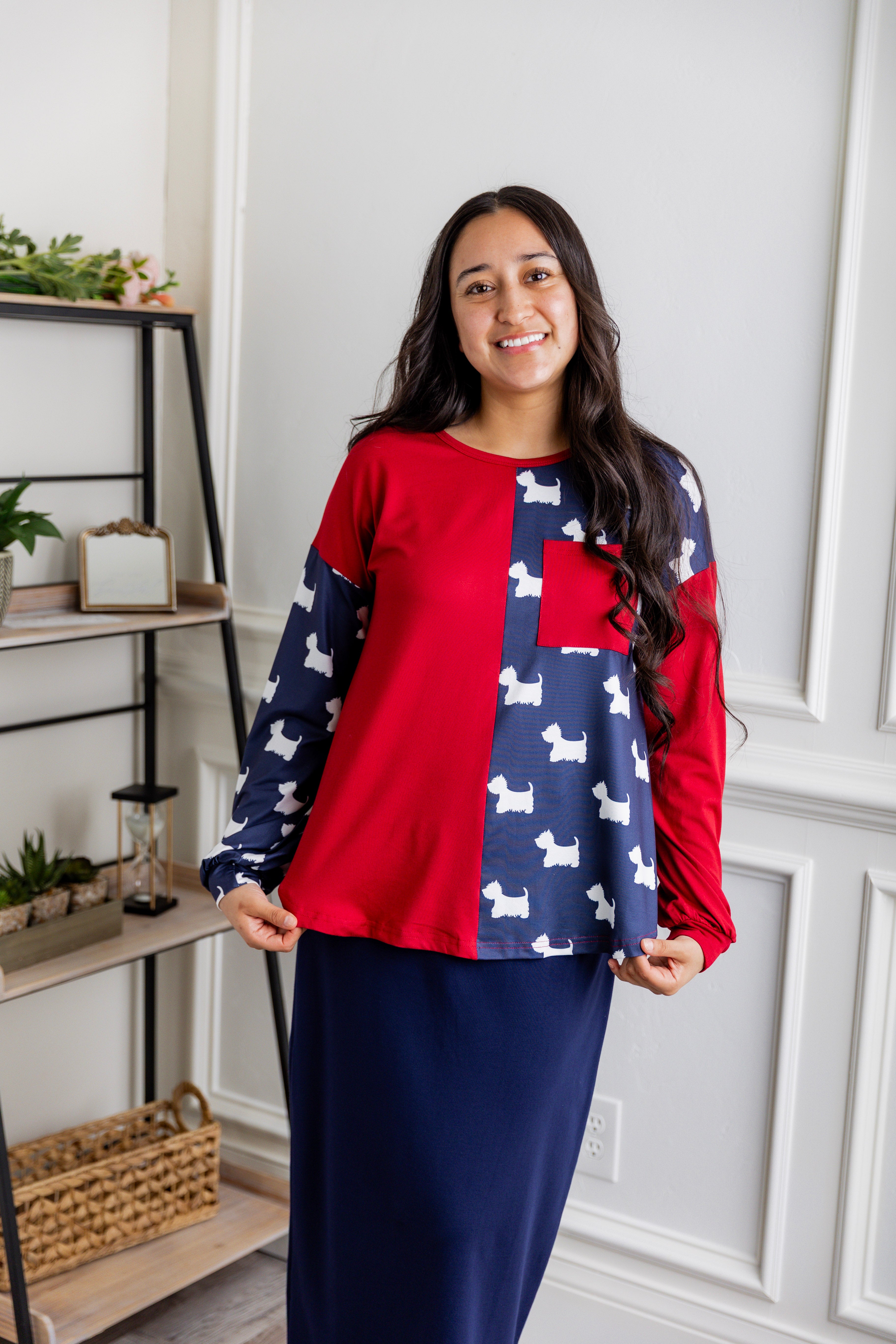 Model wearing the Nuggles® Harlow Top with red and navy color block design.