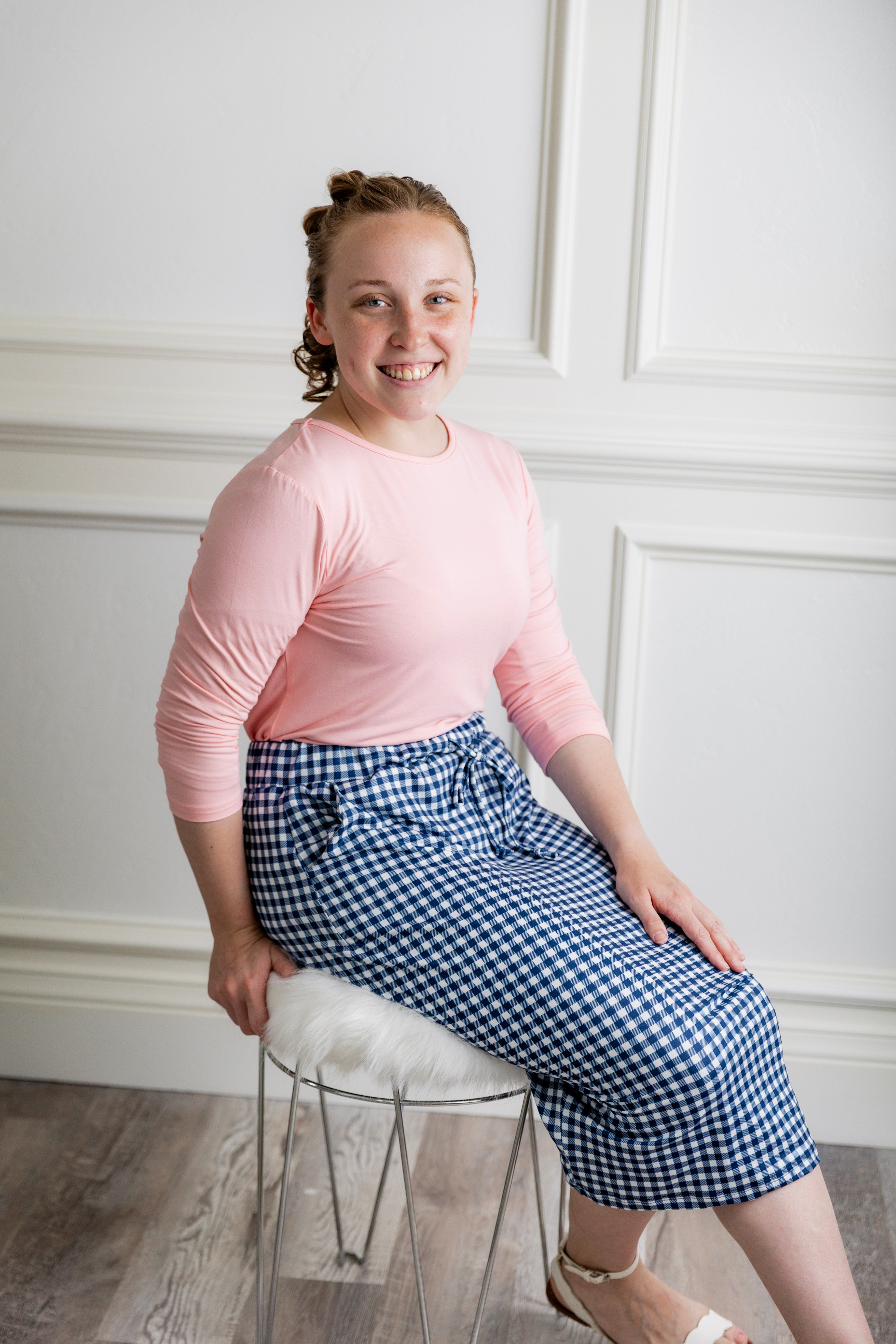Woman in a modest 27-inch blue gingham knit skirt featuring side pockets and a drawstring waistband.