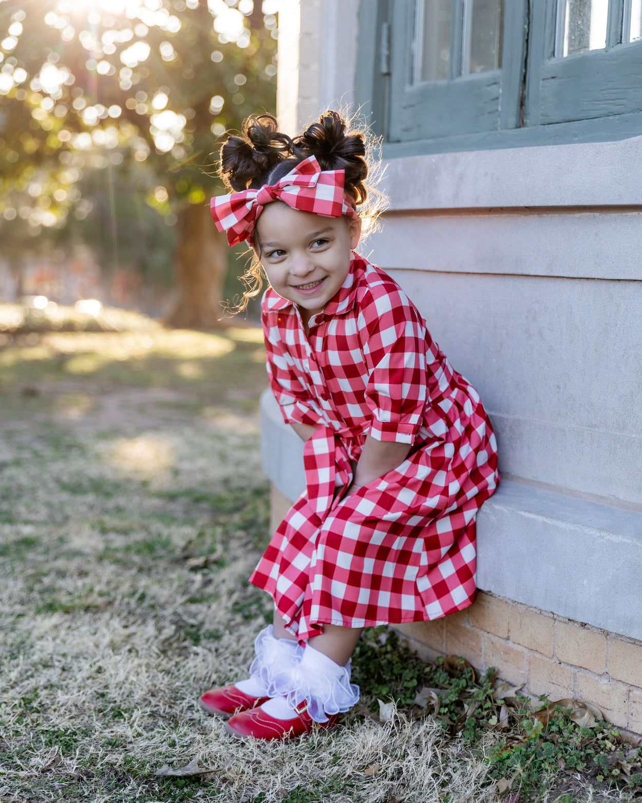 Model wearing the Nuggles® Girls' Rachel Dress in Cherry Jam