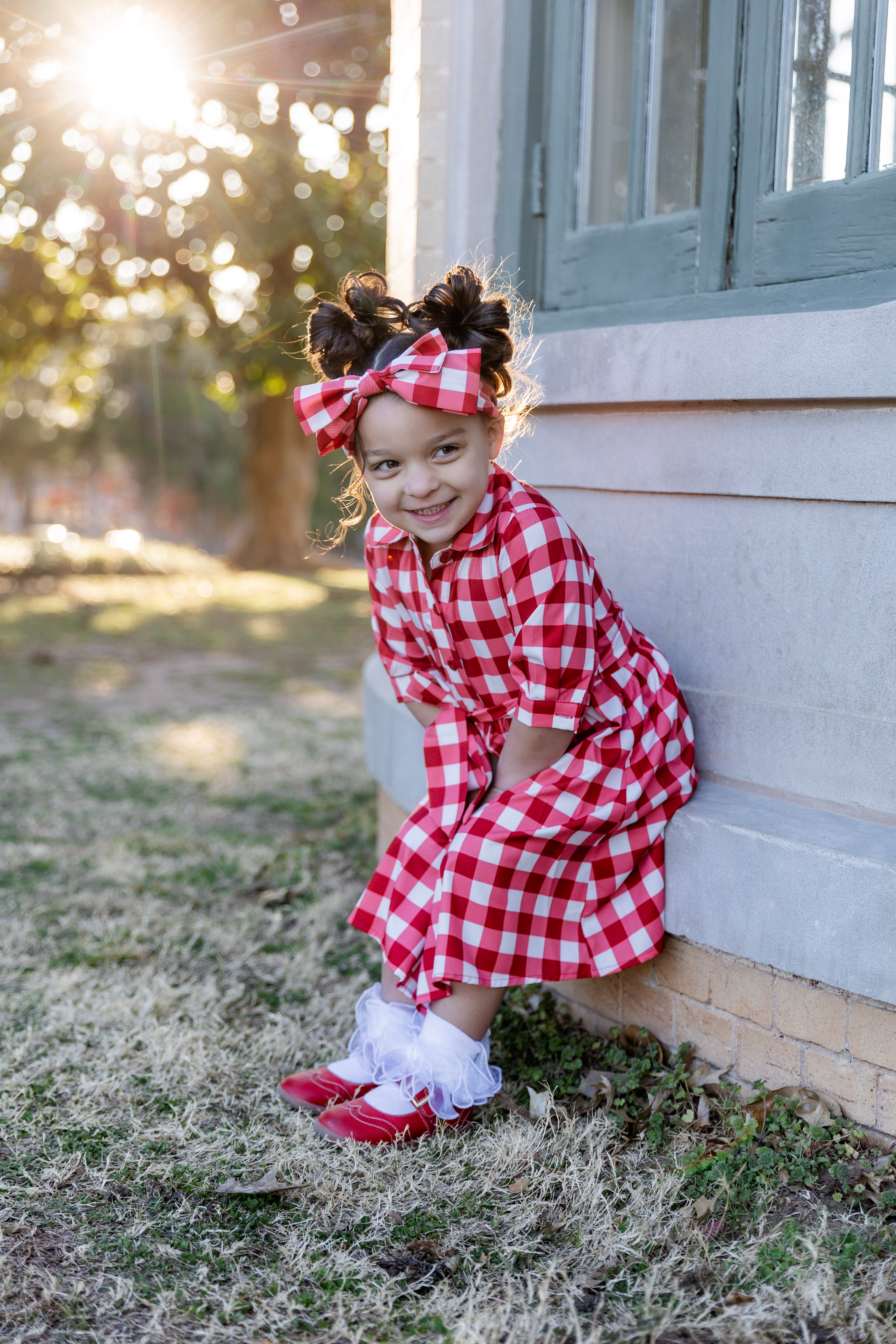 Model wearing the Nuggles® Girls' Rachel Dress in Cherry Jam