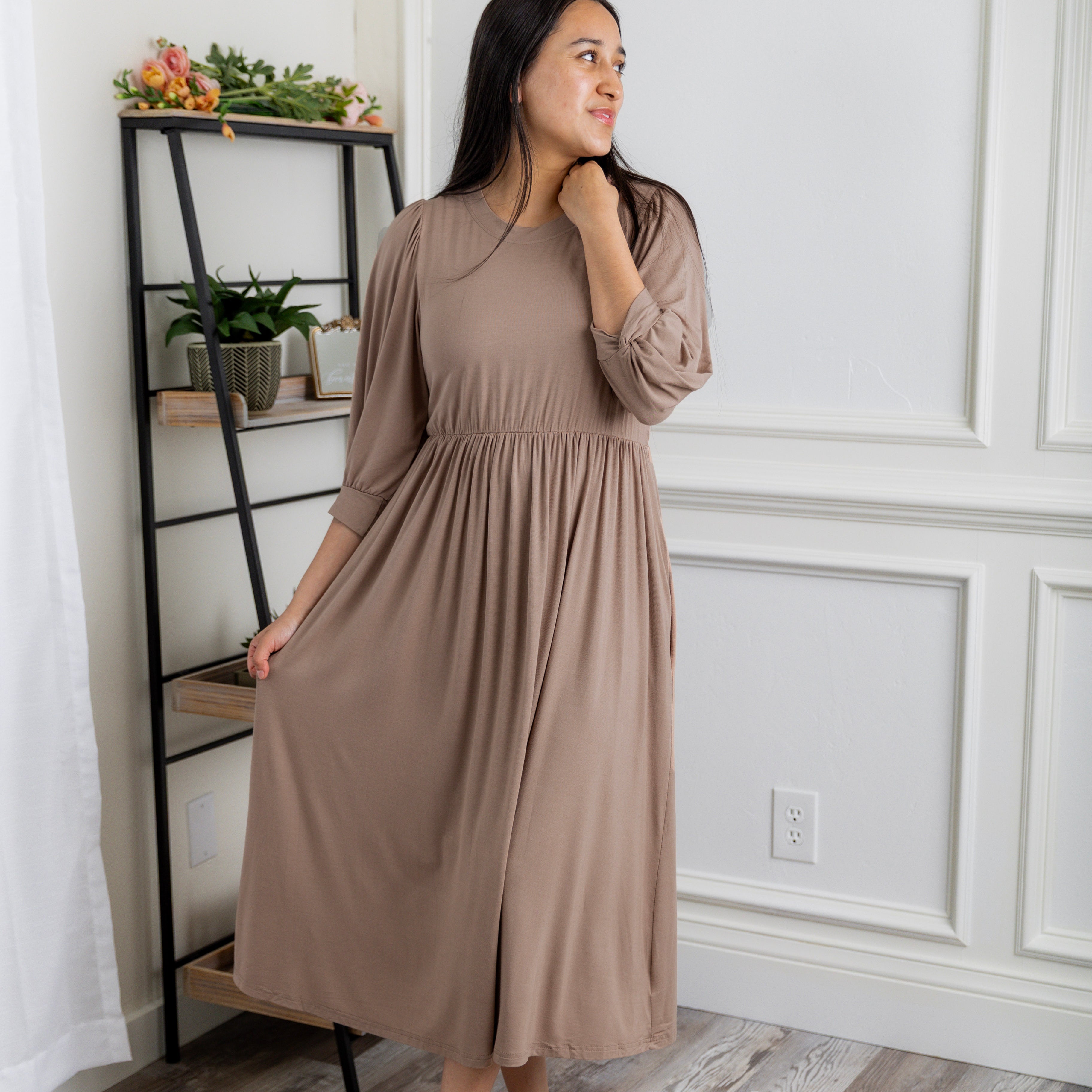 Modest Willow Solid Colors Dress by Nuggles® featuring a gathered waist, balloon sleeves, and side pockets; shown in various solid colors and angles for a stylish, comfortable everyday look.
