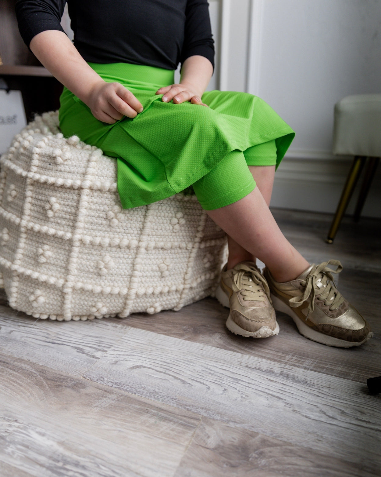 Model wearing Nuggles® Girls' All-Sport Skirt in Green