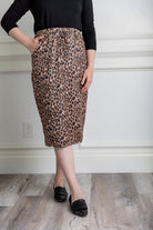 Woman wearing a modest 27-inch leopard print knit skirt with drawstring waist and side pockets.