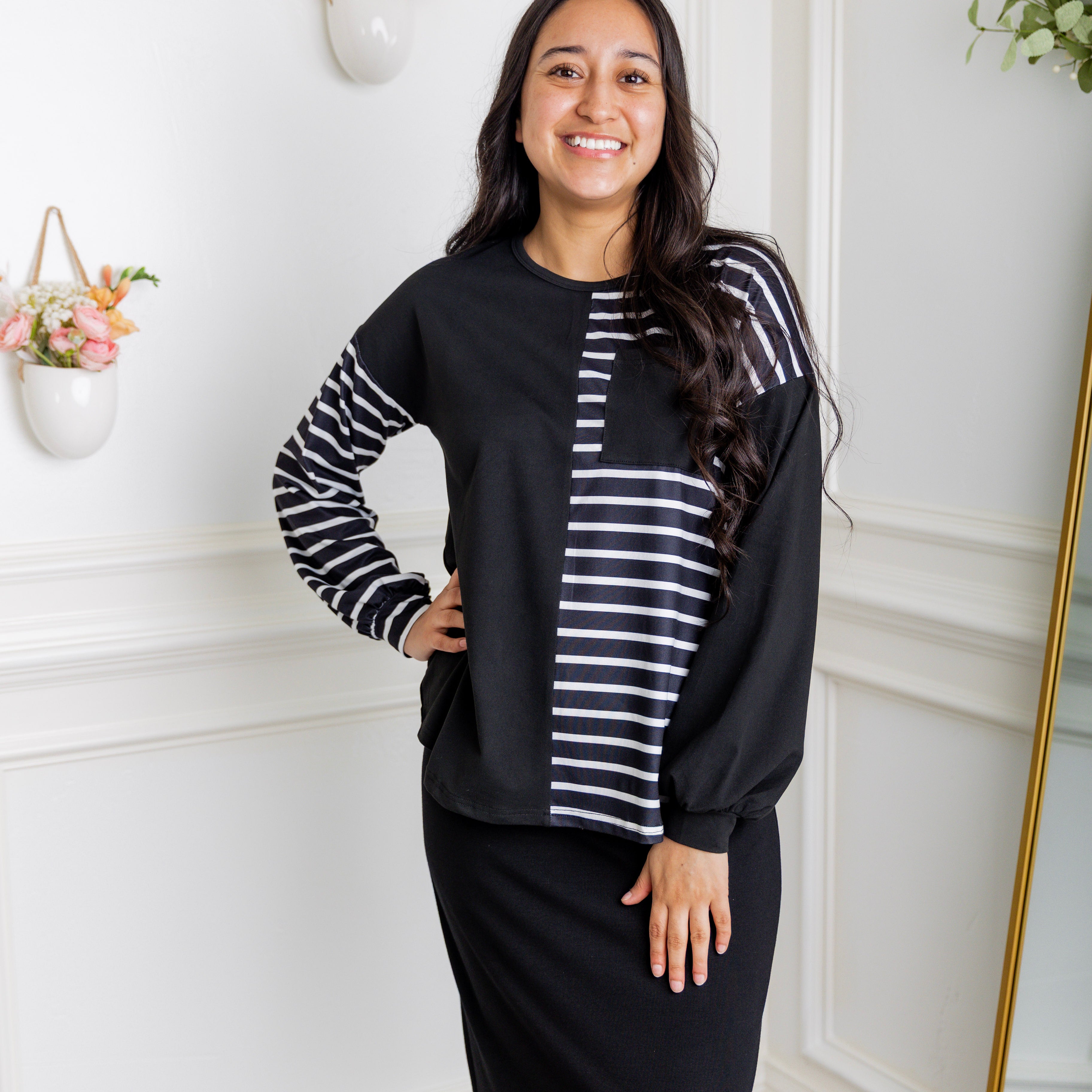 Model wearing the Nuggles® Harlow Top with red and navy color block design.