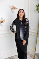 Model wearing the Nuggles® Harlow Top with red and navy color block design.