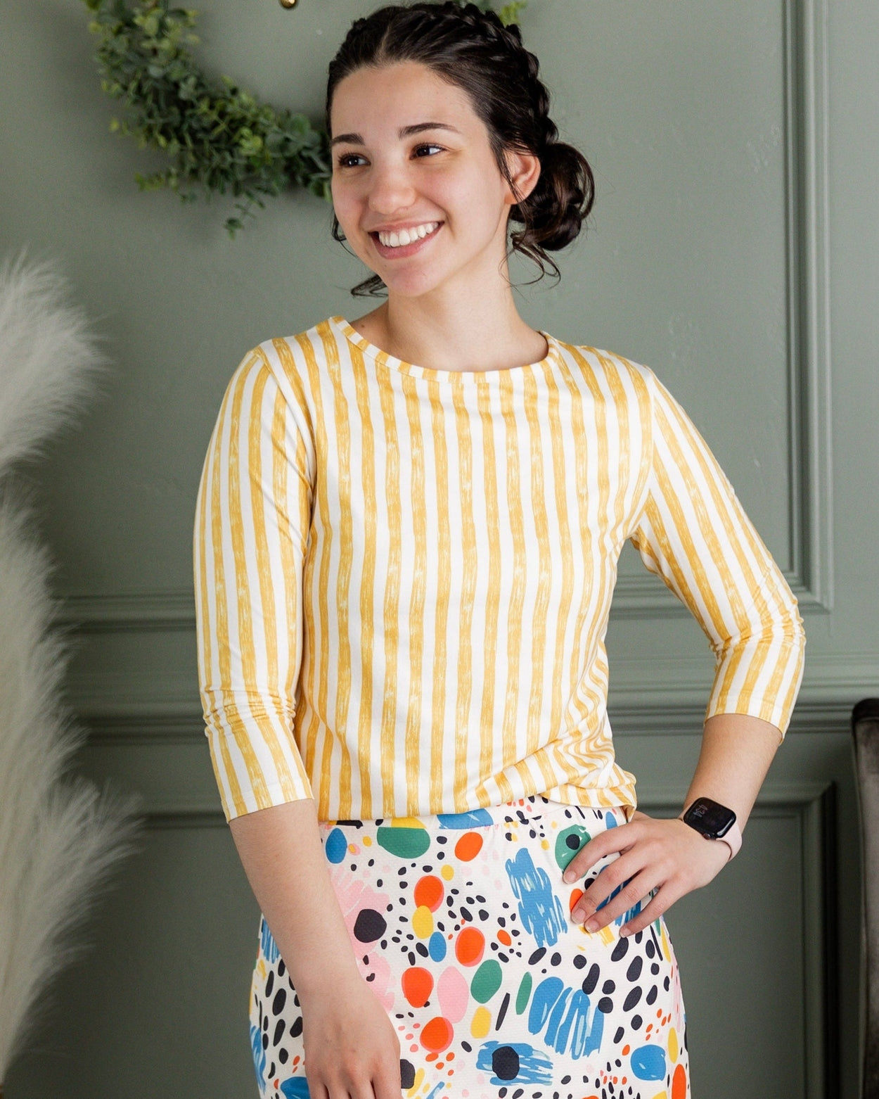 Model wearing Nuggles® 27" Sport Skirt in Party Sprinkles and 3/4 Essential Tee in Lemon Drop Stripe