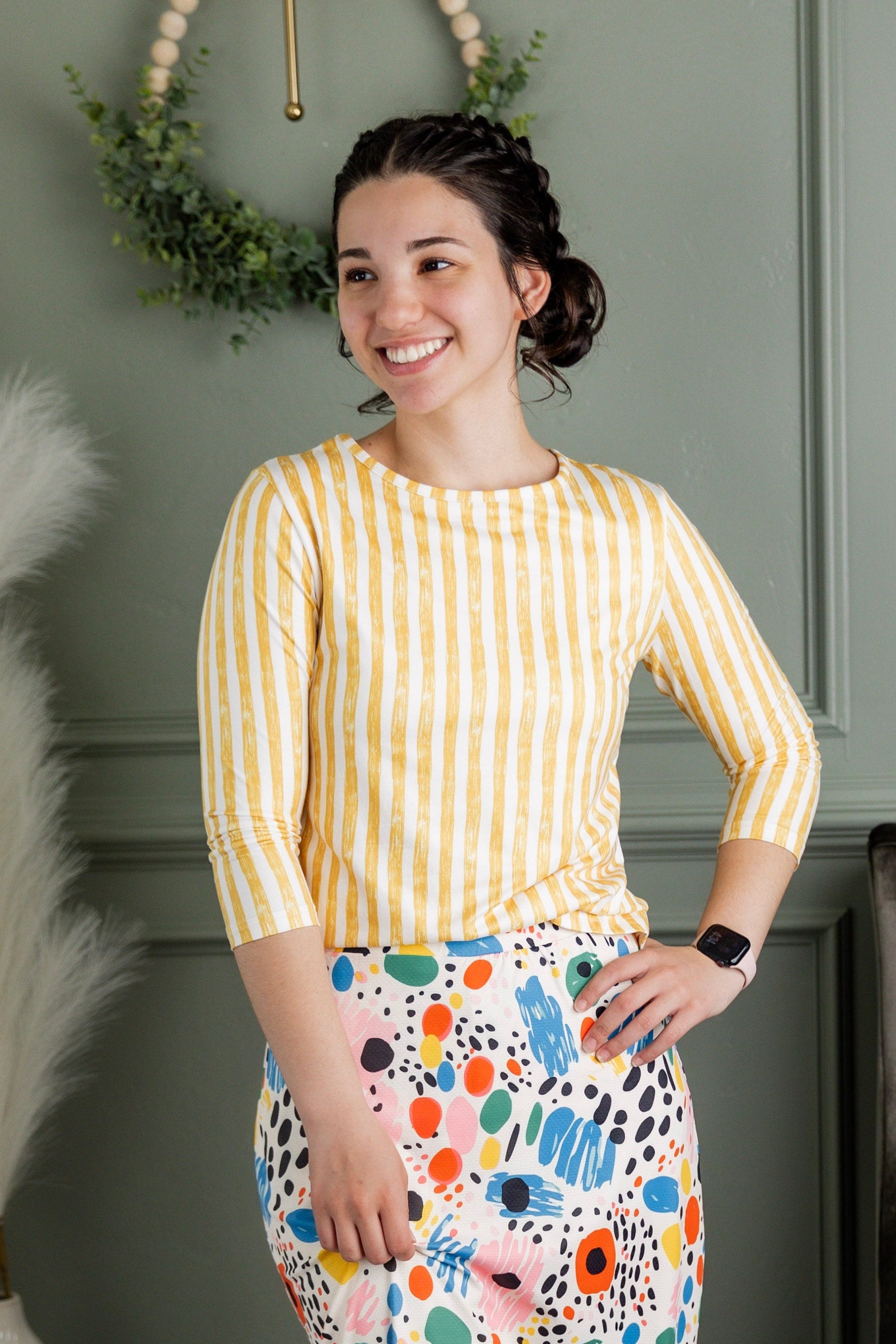 Model wearing Nuggles® 27" Sport Skirt in Party Sprinkles and 3/4 Essential Tee in Lemon Drop Stripe