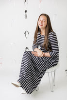 Nuggles® Cleo modest maxi dress in various prints shown with hidden pockets and fitted bodice.