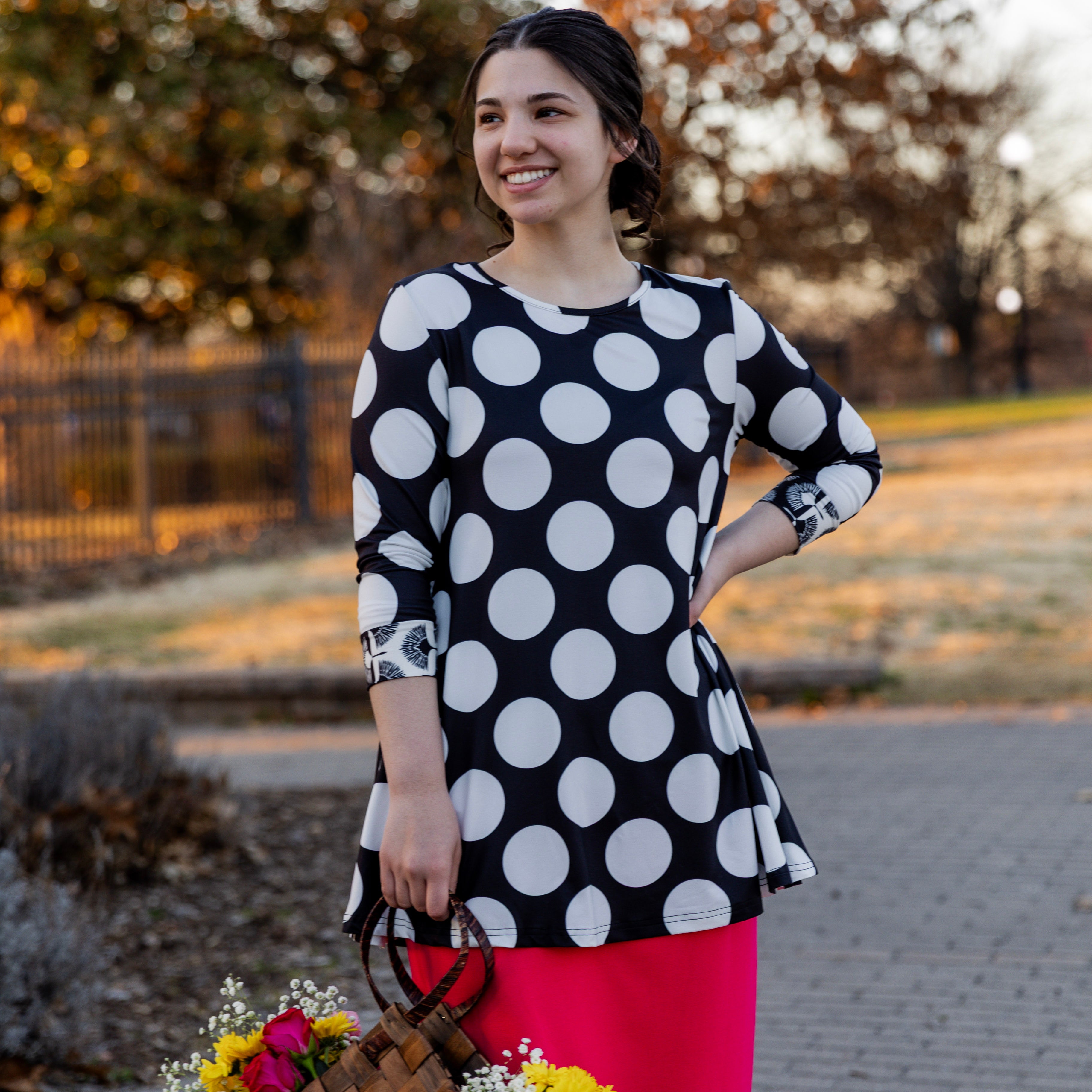 Model wearing the 3/4 Sleeve Victoria Top in floral print, paired with a modest Classic skirt. Modest women’s fashion with 3/4 sleeves and hip-length fit, perfect for church, work, or everyday wear.