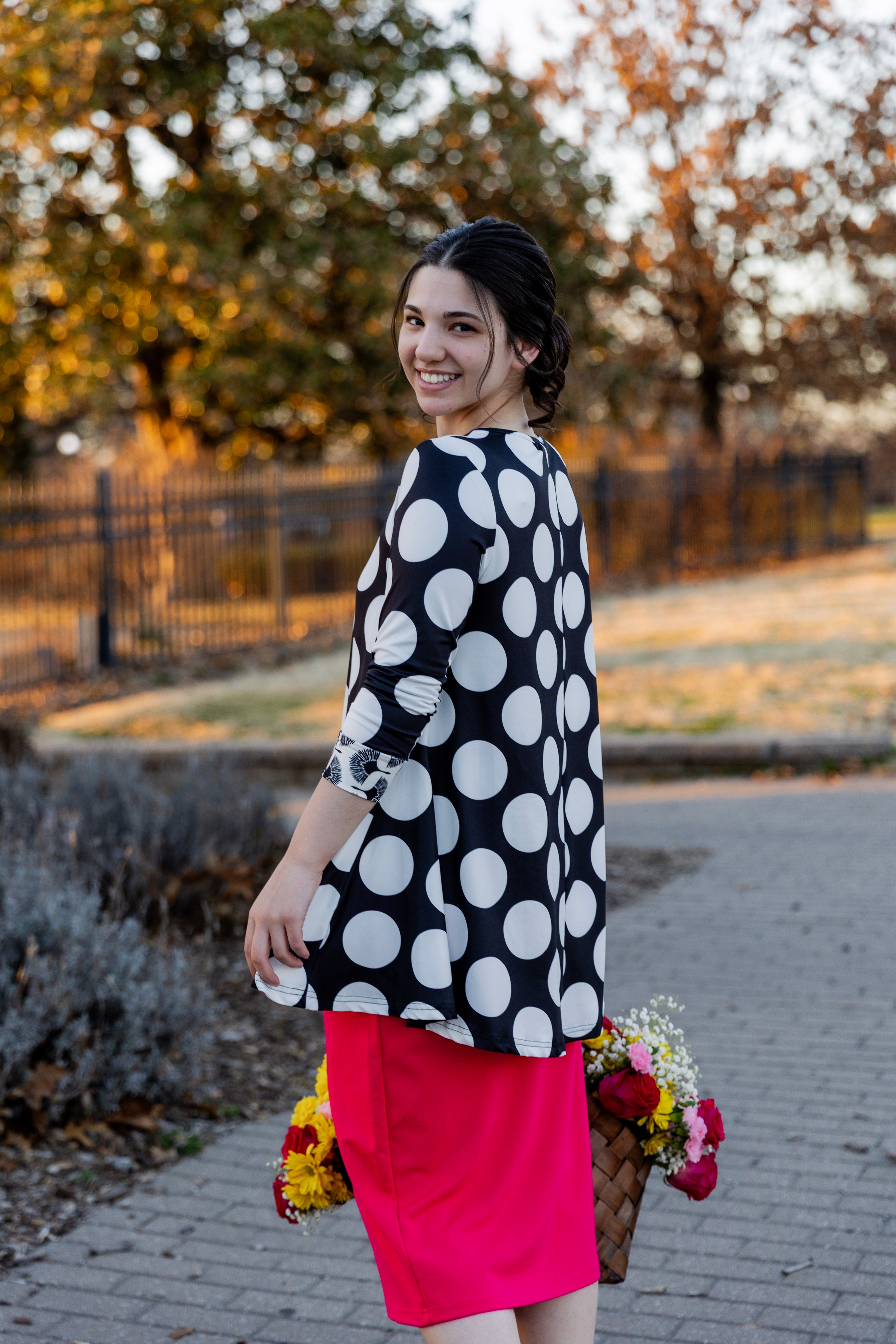 Model wearing the 3/4 Sleeve Victoria Top in floral print, paired with a modest Classic skirt. Modest women’s fashion with 3/4 sleeves and hip-length fit, perfect for church, work, or everyday wear.