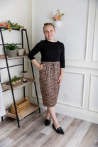 Woman wearing a modest 27-inch leopard print knit skirt with drawstring waist and side pockets.