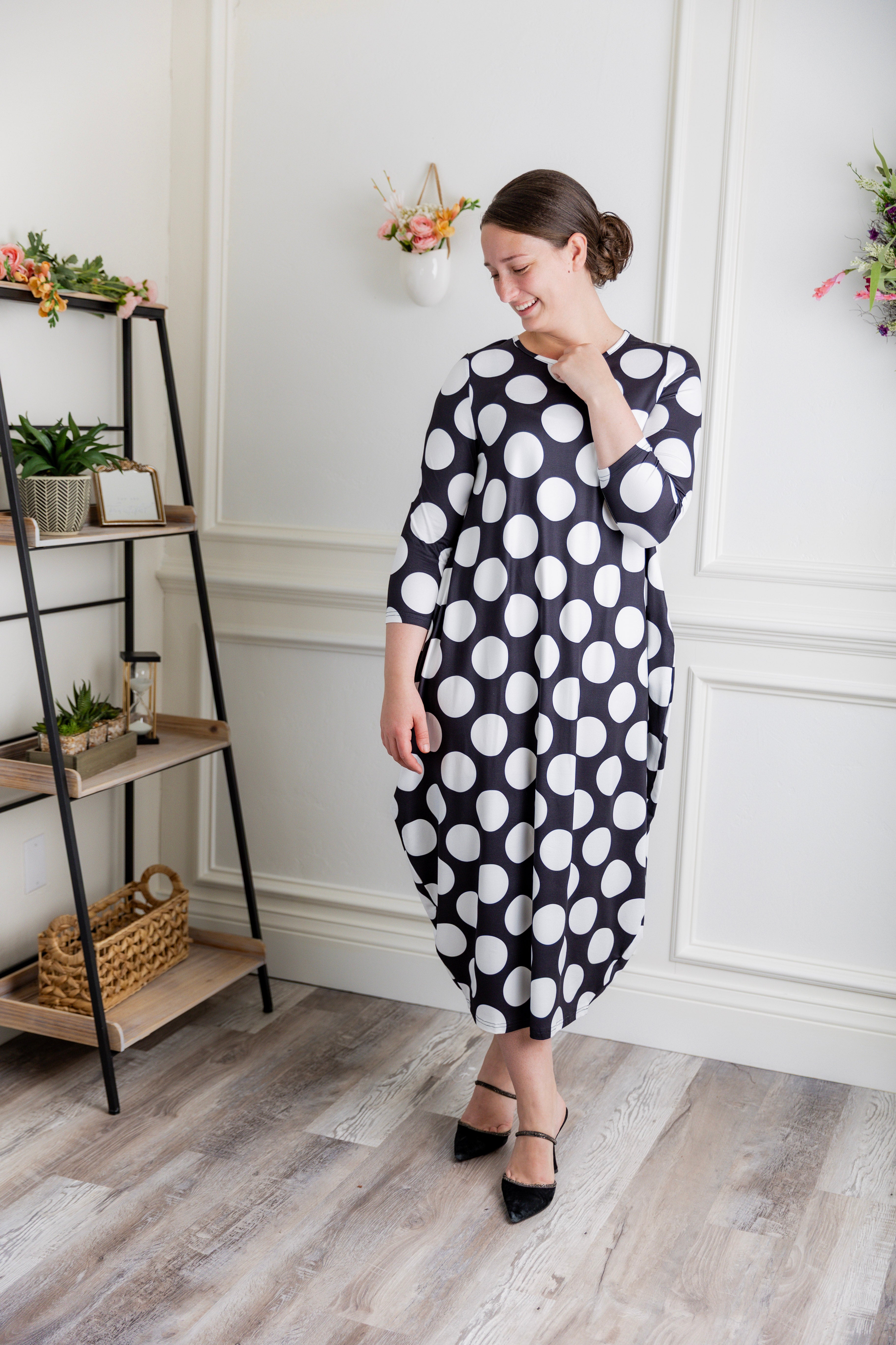 Model wearing Emma Bubble Dress in pretty prints, showcasing full bubble skirt and modest fit.