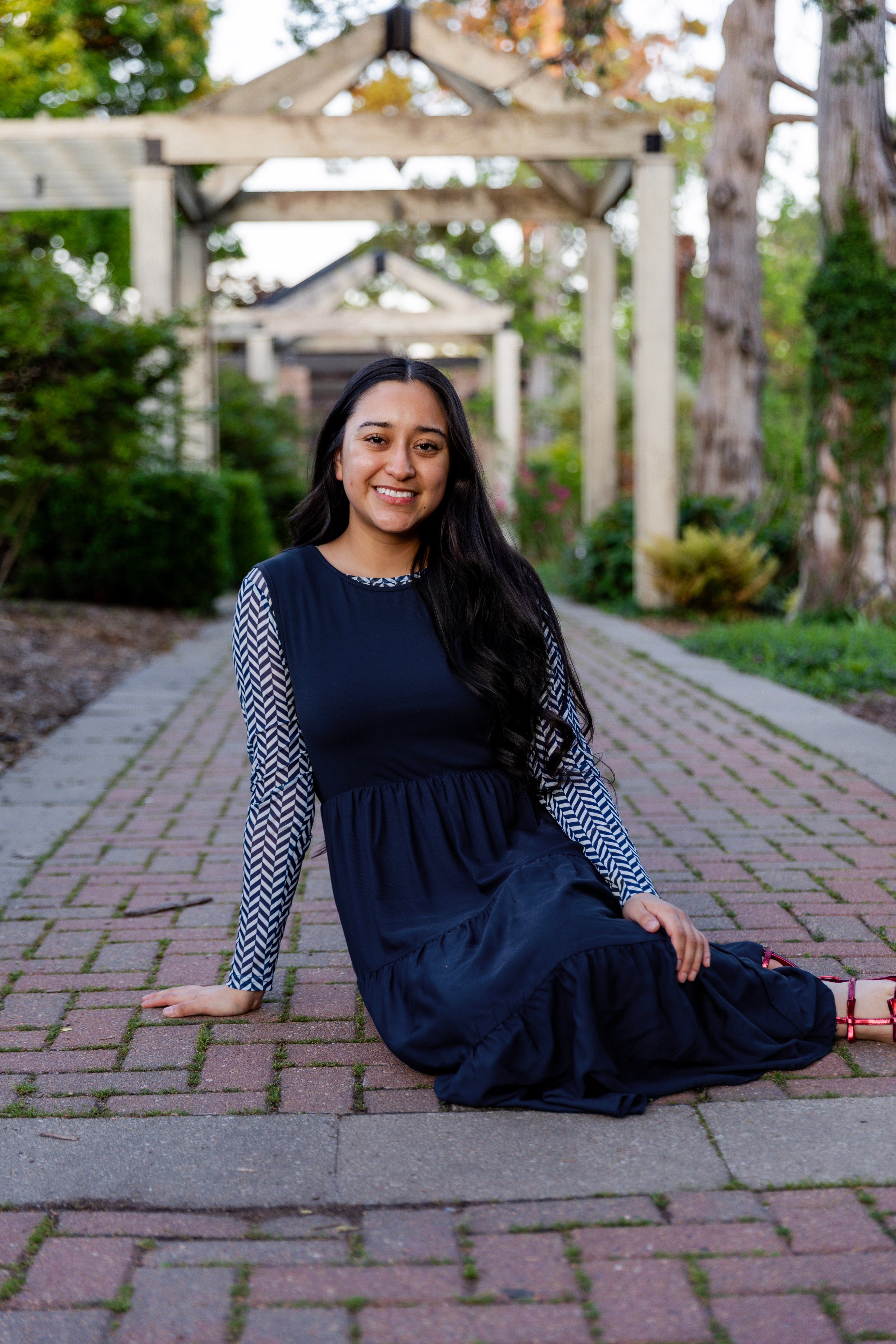Modest sleeveless midi dress with tiered skirt and fitted bodice, styled for layering with a crew neckline – Hannah Layering Dress by Nuggles®.
