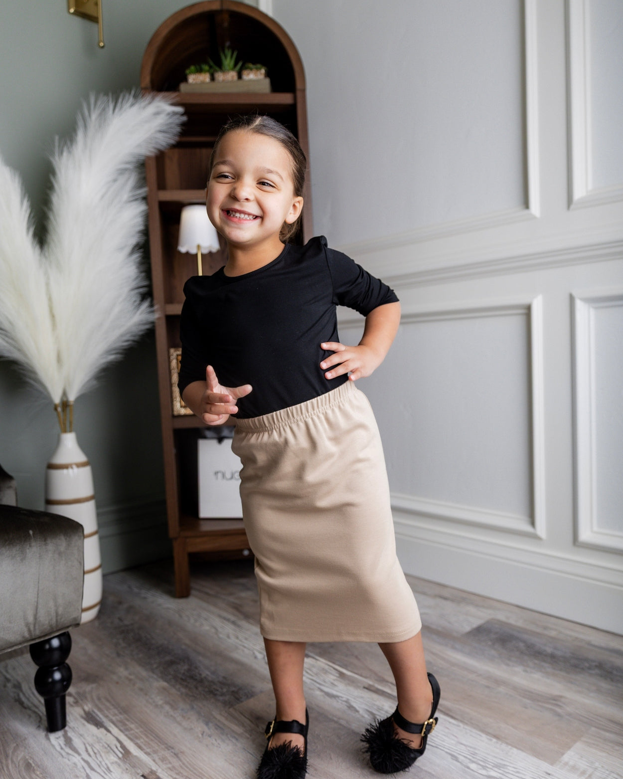 Model wearing the Nuggles® Girls' Classic Midi Skirt in Khaki
